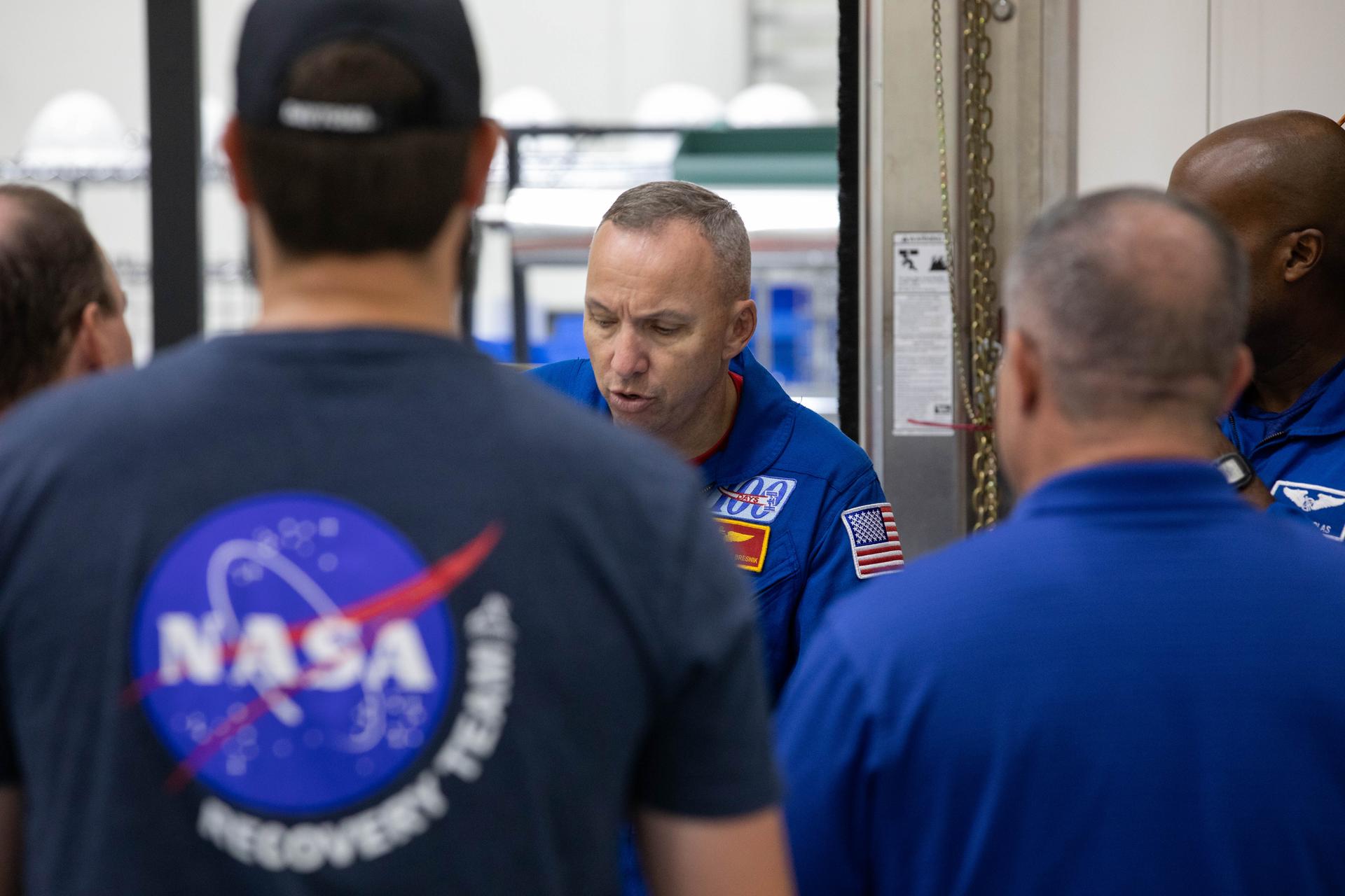 Artemis III crew members, NASA astronauts Randy Bresnick (center) and Andre Douglas (obscured) get a close look Orion spacecraft hardware inside the Multi-Payload Processing Facility at NASA’s Kennedy Space Center in Florida on Friday, July 10, 2026. Bresnick, Douglas, NASA astronaut Frank Rubio, and ESA (European Space Agency) astronaut Luca Parmitano will launch aboard Orion on the Artemis III mission to conduct critical rendezvous and docking tests with lunar lander systems in low Earth orbit, advancing the capabilities needed before astronauts return to the lunar surface on Artemis IV.
