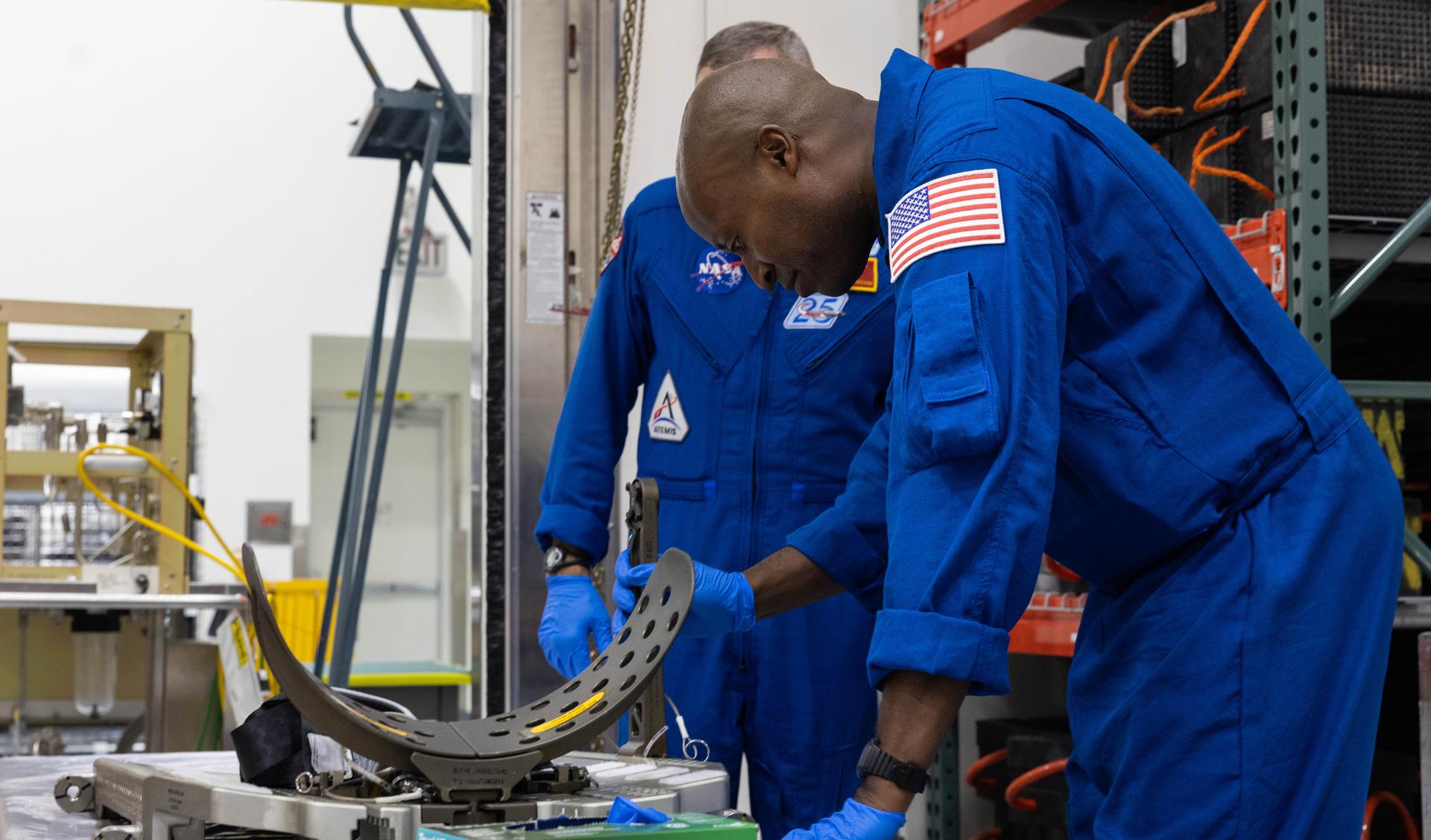 Artemis III crew members, NASA astronauts Andre Douglas and Randy Bresnick (obscured) and get a close look Orion spacecraft hardware inside the Multi-Payload Processing Facility at NASA’s Kennedy Space Center in Florida on Friday, July 10, 2026. Bresnick, Douglas, NASA astronaut Frank Rubio, and ESA (European Space Agency) astronaut Luca Parmitano will launch aboard Orion on the Artemis III mission to conduct critical rendezvous and docking tests with lunar lander systems in low Earth orbit, advancing the capabilities needed before astronauts return to the lunar surface on Artemis IV.