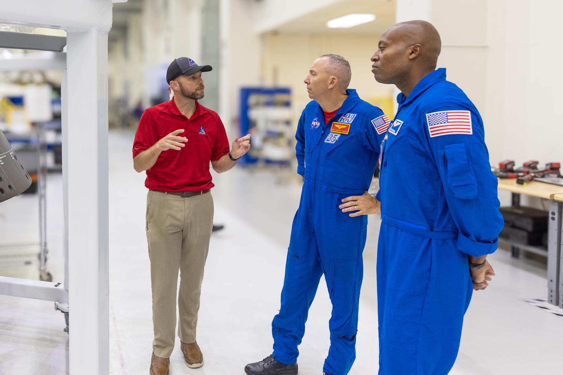 Artemis III crew members, NASA astronauts Randy Bresnick (center) and Andre Douglas (right), speak to Jim Skaggs, Spacecraft Flow Manager for Lockheed Martin, inside the high bay of the Neil A. Armstrong Operations and Checkout Building at NASA’s Kennedy Space Center in Florida on Friday, July 10, 2026. The astronauts met with Orion teams and got a closer look at the Orion spacecraft inside the facility. Bresnick, Douglas, NASA astronaut Frank Rubio, and ESA (European Space Agency) astronaut Luca Parmitano will launch on the Artemis III mission to conduct critical rendezvous and docking tests with lunar lander systems in low Earth orbit, advancing the capabilities needed before astronauts return to the lunar surface on Artemis IV.