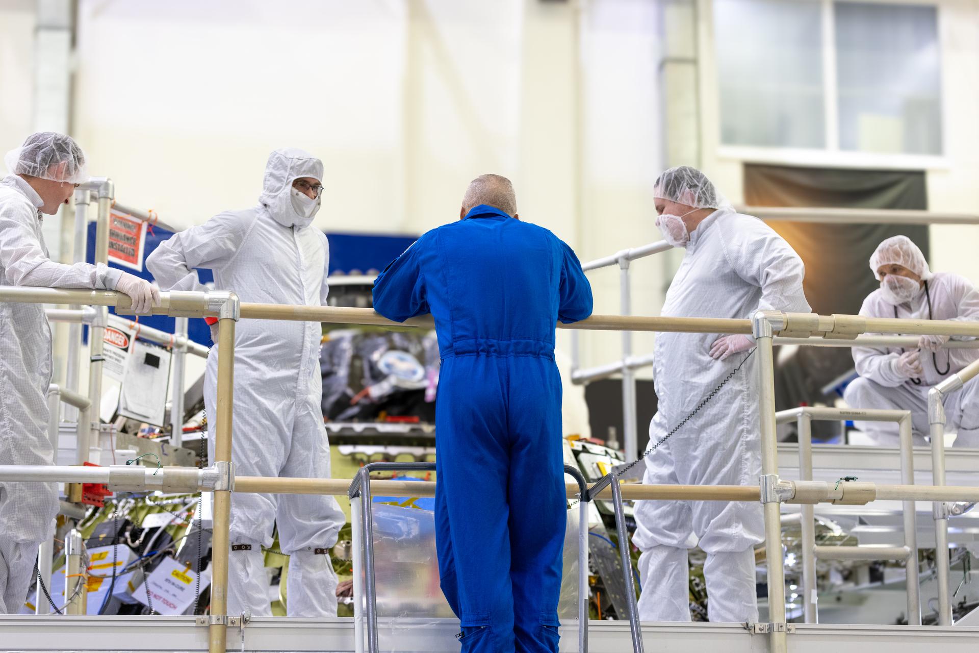 Artemis III commander, NASA astronaut Randy Bresnick (center), speaks with members of NASA’s Orion spacecraft team in front of the Artemis III crew module inside the high bay of the Neil A. Armstrong Operations and Checkout Building at NASA’s Kennedy Space Center in Florida on Friday, July 10, 2026. Bresnick and fellow Artemis III crew member, NASA astronaut Andre Douglas, met with Orion teams and got a close look at the work underway for their upcoming mission. Bresnick, Douglas, NASA astronaut Frank Rubio, and ESA (European Space Agency) astronaut Luca Parmitano will launch on the Artemis III mission to conduct critical rendezvous and docking tests with lunar lander systems in low Earth orbit, advancing the capabilities needed before astronauts return to the lunar surface on Artemis IV.