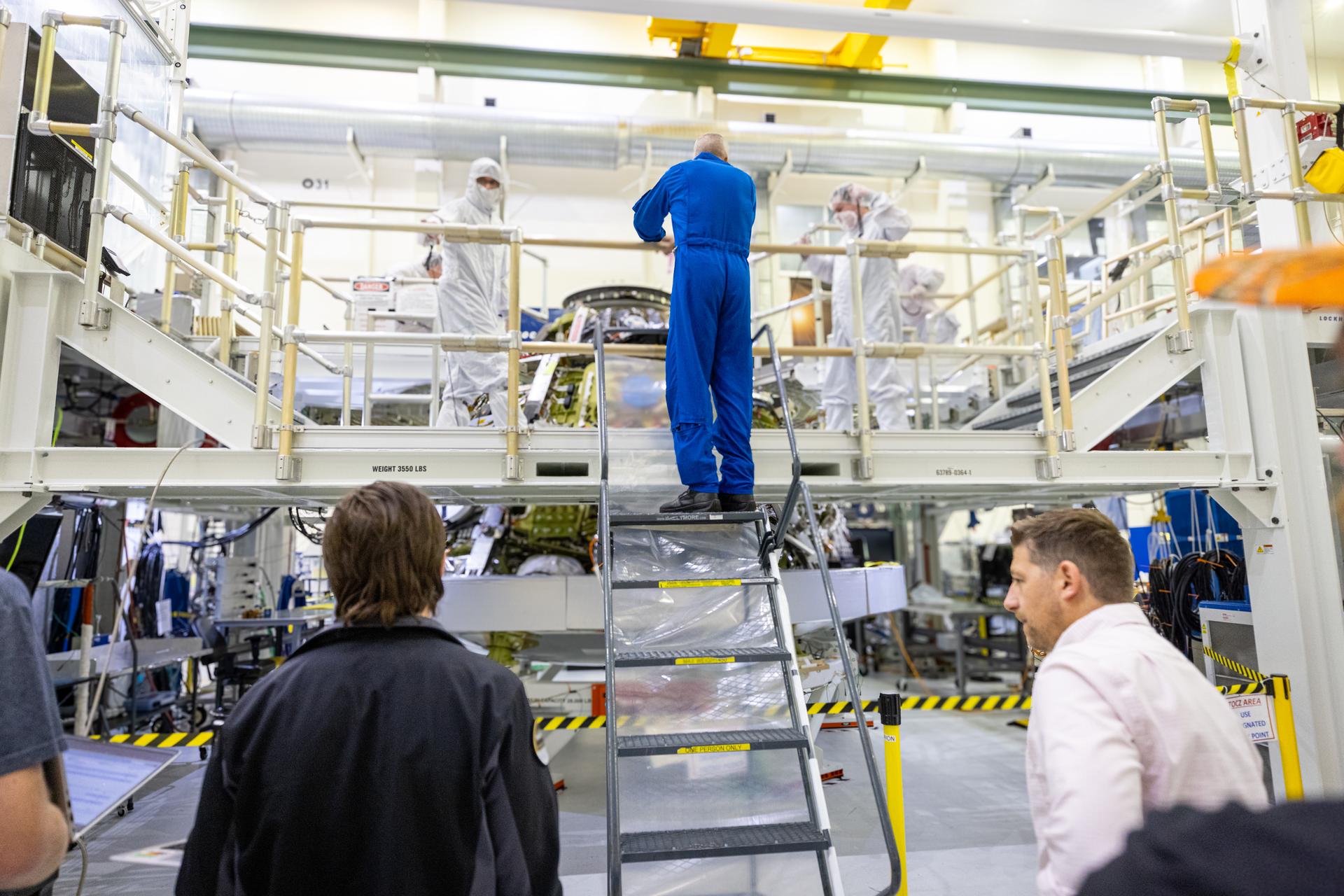 Artemis III commander, NASA astronaut Randy Bresnick (center), speaks with members of NASA’s Orion spacecraft team in front of the Artemis III crew module inside the high bay of the Neil A. Armstrong Operations and Checkout Building at NASA’s Kennedy Space Center in Florida on Friday, July 10, 2026. Bresnick and fellow Artemis III crew member, NASA astronaut Andre Douglas, met with Orion teams and got a close look at the work underway for their upcoming mission. Bresnick, Douglas, NASA astronaut Frank Rubio, and ESA (European Space Agency) astronaut Luca Parmitano will launch on the Artemis III mission to conduct critical rendezvous and docking tests with lunar lander systems in low Earth orbit, advancing the capabilities needed before astronauts return to the lunar surface on Artemis IV.