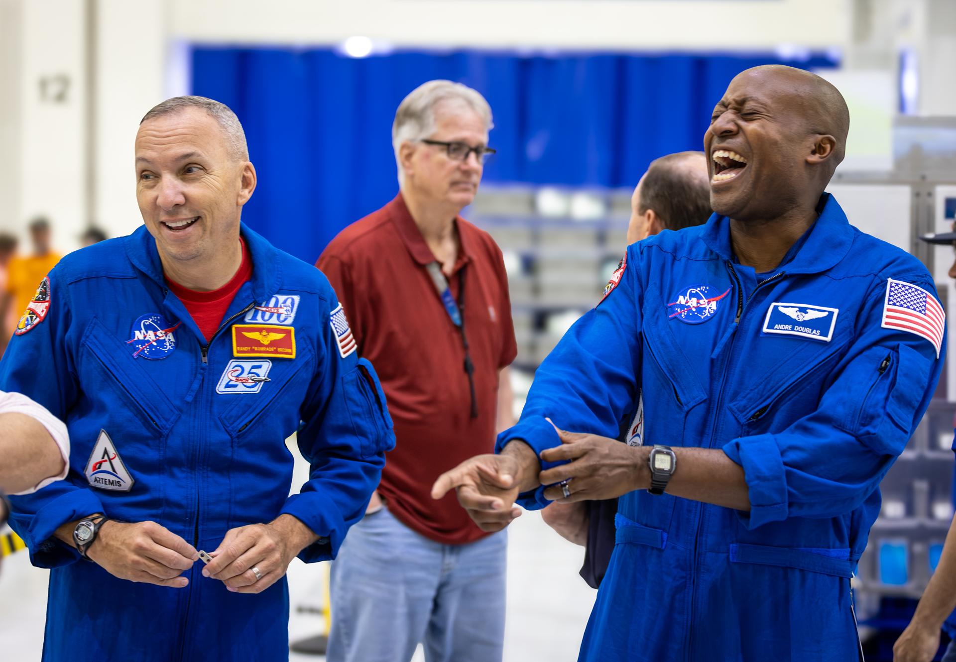 Artemis III crew members, NASA astronauts Randy Bresnick (left) and Andre Douglas (right), share a laugh with members of NASA’s Orion team inside the high bay of the Neil A. Armstrong Operations and Checkout Building at NASA’s Kennedy Space Center in Florida on Friday, July 10, 2026. The astronauts met with Orion teams and got a close look at the work underway on the Orion spacecraft inside the facility. Bresnick, Douglas, NASA astronaut Frank Rubio, and ESA (European Space Agency) astronaut Luca Parmitano will launch on the Artemis III mission to conduct critical rendezvous and docking tests with lunar lander systems in low Earth orbit, advancing the capabilities needed before astronauts return to the lunar surface on Artemis IV.