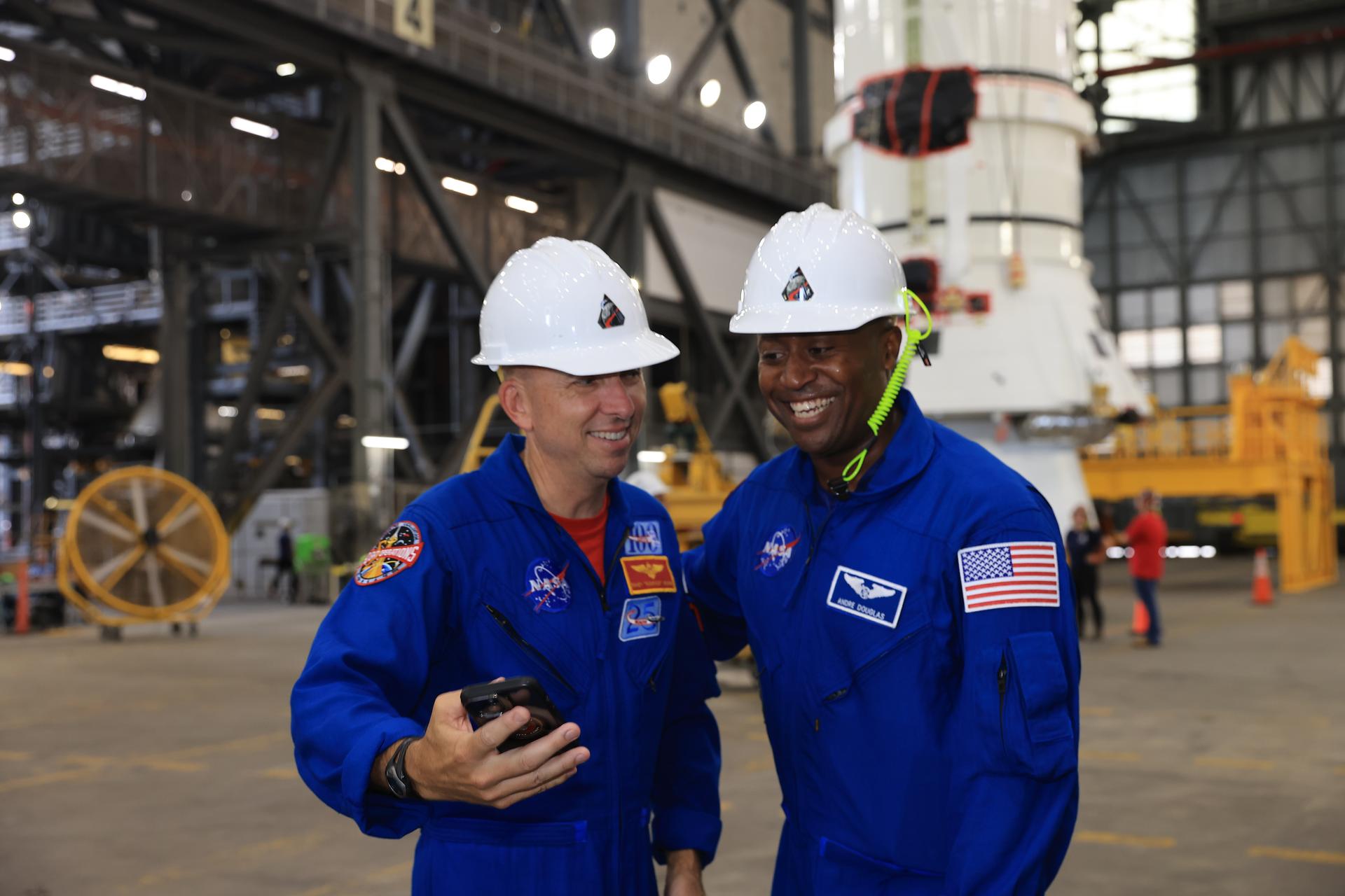 Artemis III crew members, NASA astronauts Randy Bresnick (left) and Andre Douglas, take a selfie in front of the right-hand aft assembly solid rocket booster segment of the Artemis III SLS (Space Launch System) rocket inside the Vehicle Assembly Building at NASA’s Kennedy Space Center in Florida on Friday, July 10, 2026. The astronauts met with NASA’s Exploration Ground Systems teams and got a close look at the work underway for their upcoming mission. Bresnick, Douglas, NASA astronaut Frank Rubio, and ESA (European Space Agency) astronaut Luca Parmitano will launch on the Artemis III mission to conduct critical rendezvous and docking tests with lunar lander systems in low Earth orbit, advancing the capabilities needed before astronauts return to the lunar surface on Artemis IV.