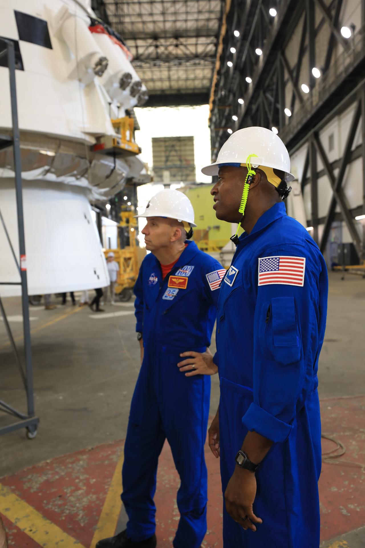 Artemis III crew members, NASA astronauts Randy Bresnick (left) and Andre Douglas, view the right-hand aft assembly solid rocket booster segment of the Artemis III SLS (Space Launch System) rocket inside the Vehicle Assembly Building at NASA’s Kennedy Space Center in Florida on Friday, July 10, 2026. The astronauts met with NASA’s Exploration Ground Systems teams and got a close look at the work underway for their upcoming mission. Bresnick, Douglas, NASA astronaut Frank Rubio, and ESA (European Space Agency) astronaut Luca Parmitano will launch on the Artemis III mission to conduct critical rendezvous and docking tests with lunar lander systems in low Earth orbit, advancing the capabilities needed before astronauts return to the lunar surface on Artemis IV.