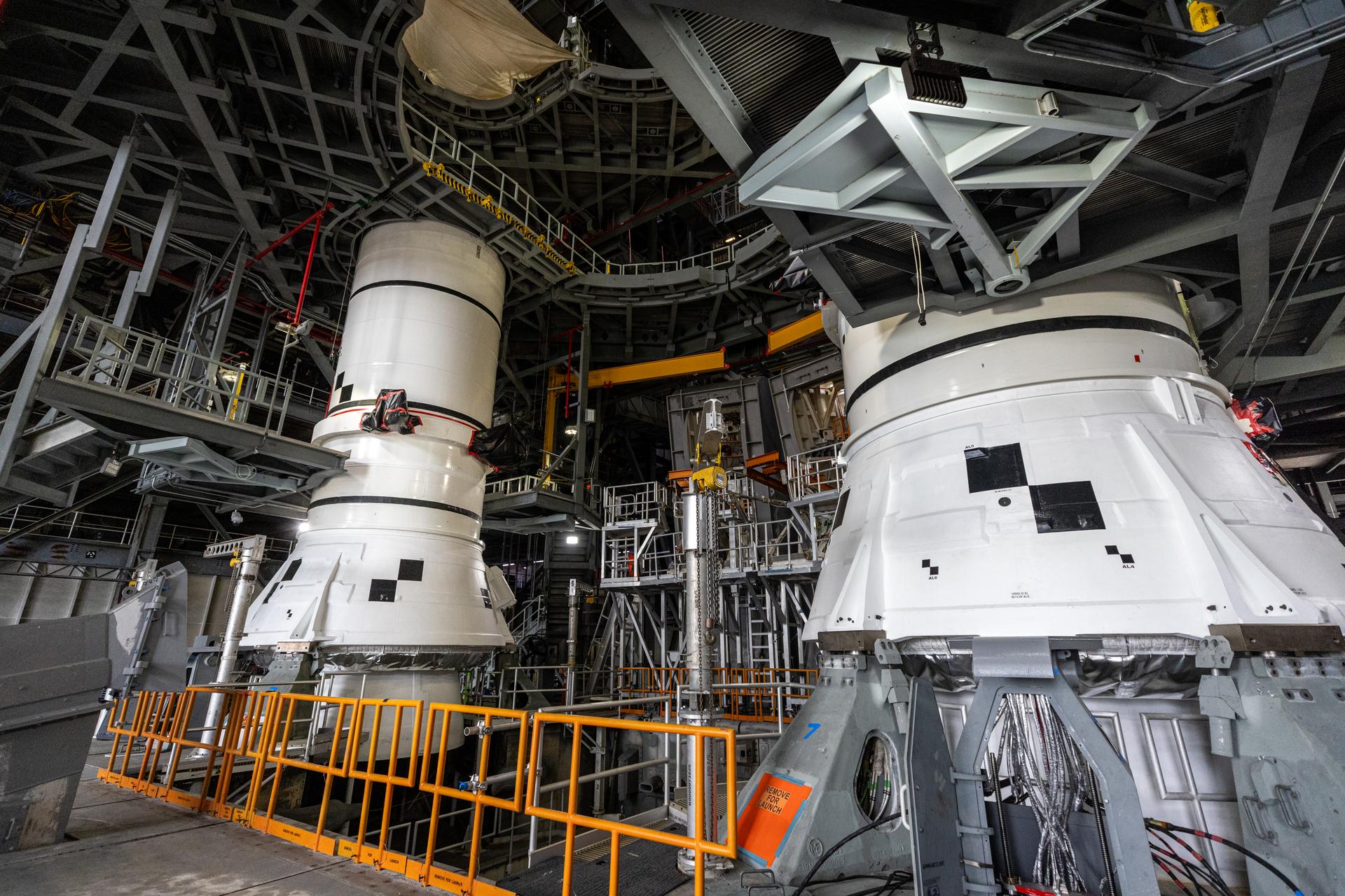 The left-hand and right-hand aft assembly solid rocket booster segments for NASA’s Artemis III SLS (Space Launch System) rocket are secured to the mobile launcher at the agency’s Vehicle Assembly Building at NASA’s Kennedy Space Center in Florida on Saturday, July 11, 2026. The twin boosters, manufactured by Northrop Grumman in Utah, will provide more than 75 percent of the SLS rocket’s total thrust at launch. The Artemis III mission will launch astronauts in the Orion spacecraft on top of the SLS rocket to test rendezvous and docking capabilities between Orion and commercial spacecraft needed to land astronauts on the Moon.