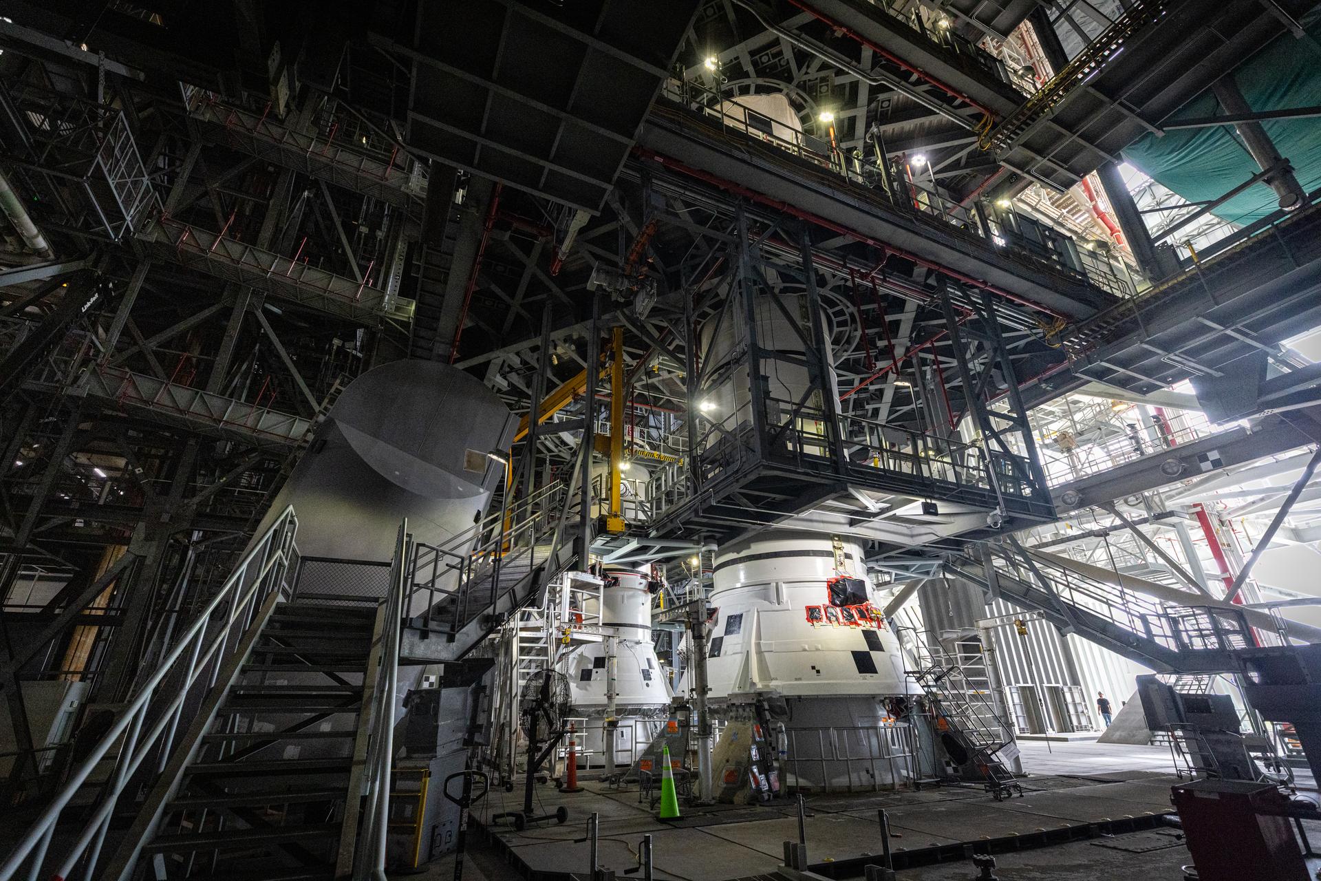 The left-hand and right-hand aft assembly solid rocket booster segments for NASA’s Artemis III SLS (Space Launch System) rocket are secured to the mobile launcher at the agency’s Vehicle Assembly Building at NASA’s Kennedy Space Center in Florida on Saturday, July 11, 2026. The twin boosters, manufactured by Northrop Grumman in Utah, will provide more than 75 percent of the SLS rocket’s total thrust at launch. The Artemis III mission will launch astronauts in the Orion spacecraft on top of the SLS rocket to test rendezvous and docking capabilities between Orion and commercial spacecraft needed to land astronauts on the Moon.