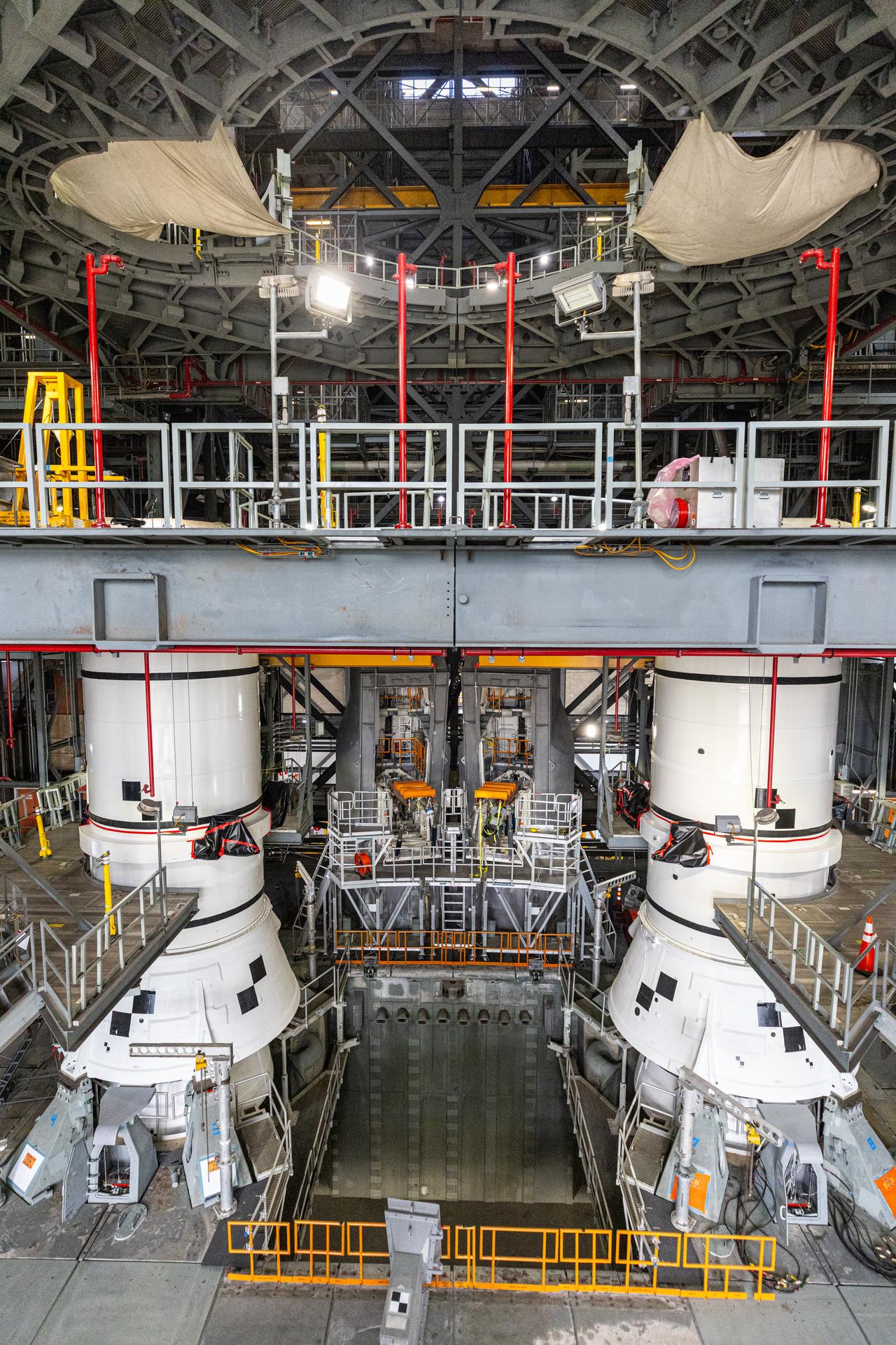 The left-hand and right-hand aft assembly solid rocket booster segments for NASA’s Artemis III SLS (Space Launch System) rocket are secured to the mobile launcher at the agency’s Vehicle Assembly Building at NASA’s Kennedy Space Center in Florida on Saturday, July 11, 2026. The twin boosters, manufactured by Northrop Grumman in Utah, will provide more than 75 percent of the SLS rocket’s total thrust at launch. The Artemis III mission will launch astronauts in the Orion spacecraft on top of the SLS rocket to test rendezvous and docking capabilities between Orion and commercial spacecraft needed to land astronauts on the Moon.