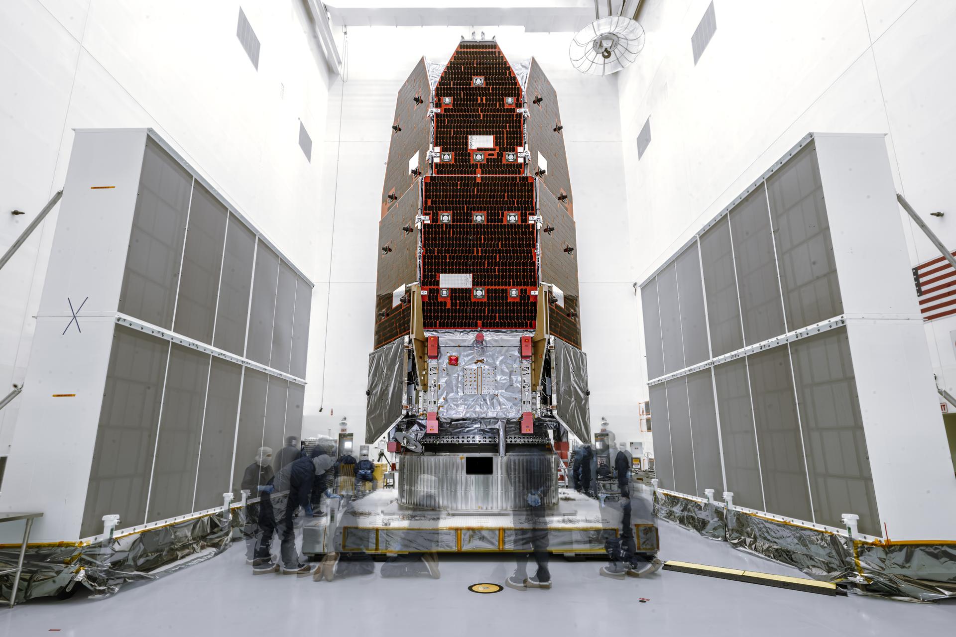 In this long exposure image, members of NASA's Nancy Grace Roman Space Telescope process the observatory on Thursday, July 16, 2026, inside the Payload Hazardous Servicing Facility at NASA’s Kennedy Space Center in Florida. Roman’s primary mission is to settle essential questions about dark energy, exoplanets, and infrared astrophysics by conducting wide-field surveys that explore the universe’s structure, evolution, and composition. Liftoff atop a SpaceX Falcon Heavy rocket from NASA Kennedy’s Launch Complex 39A is targeted no earlier than Sunday, Aug. 30, 2026.