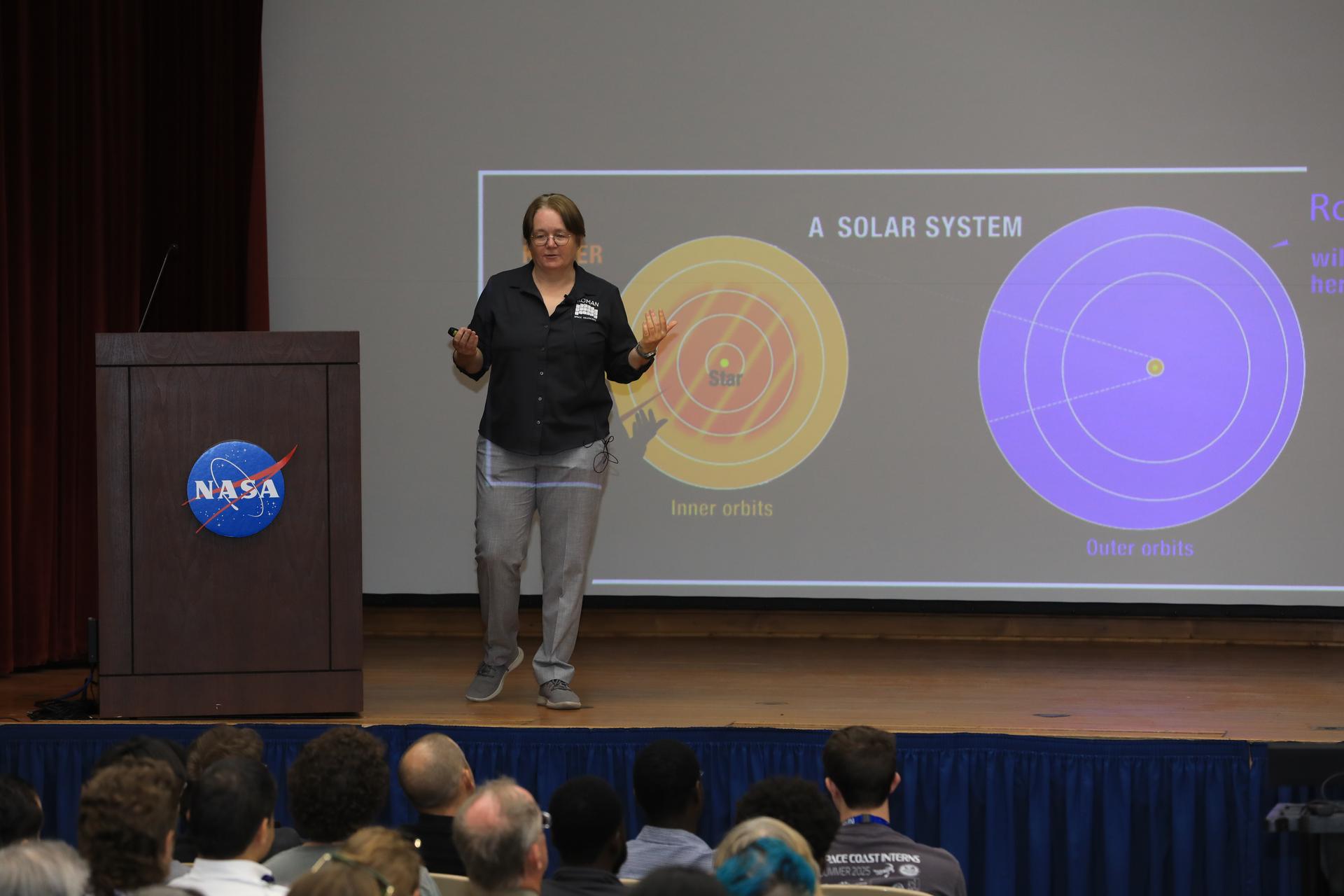 Dr. Julie McEnery, senior project scientist for NASA’s Nancy Grace Roman Space Telescope mission, discusses the upcoming Roman mission in the Training Auditorium at NASA’s Kennedy Space Center in Florida on Tuesday, July 21, 2026. McEnery is a leading astrophysicist at NASA's Goddard Space Flight Center in Greenbelt, Maryland, where she specializes in the study of high energy astrophysics and her work is expanding our understanding of the universe’s creation and behavior. Named for NASA’s first chief astronomer and “mother of the Hubble Space Telescope,” Roman will offer a field of view over 100 times larger than Hubble’s to study up to a billion galaxies, directly image exoplanets and planet forming disks, and address fundamental questions about dark energy, exoplanets, and infrared astrophysics.