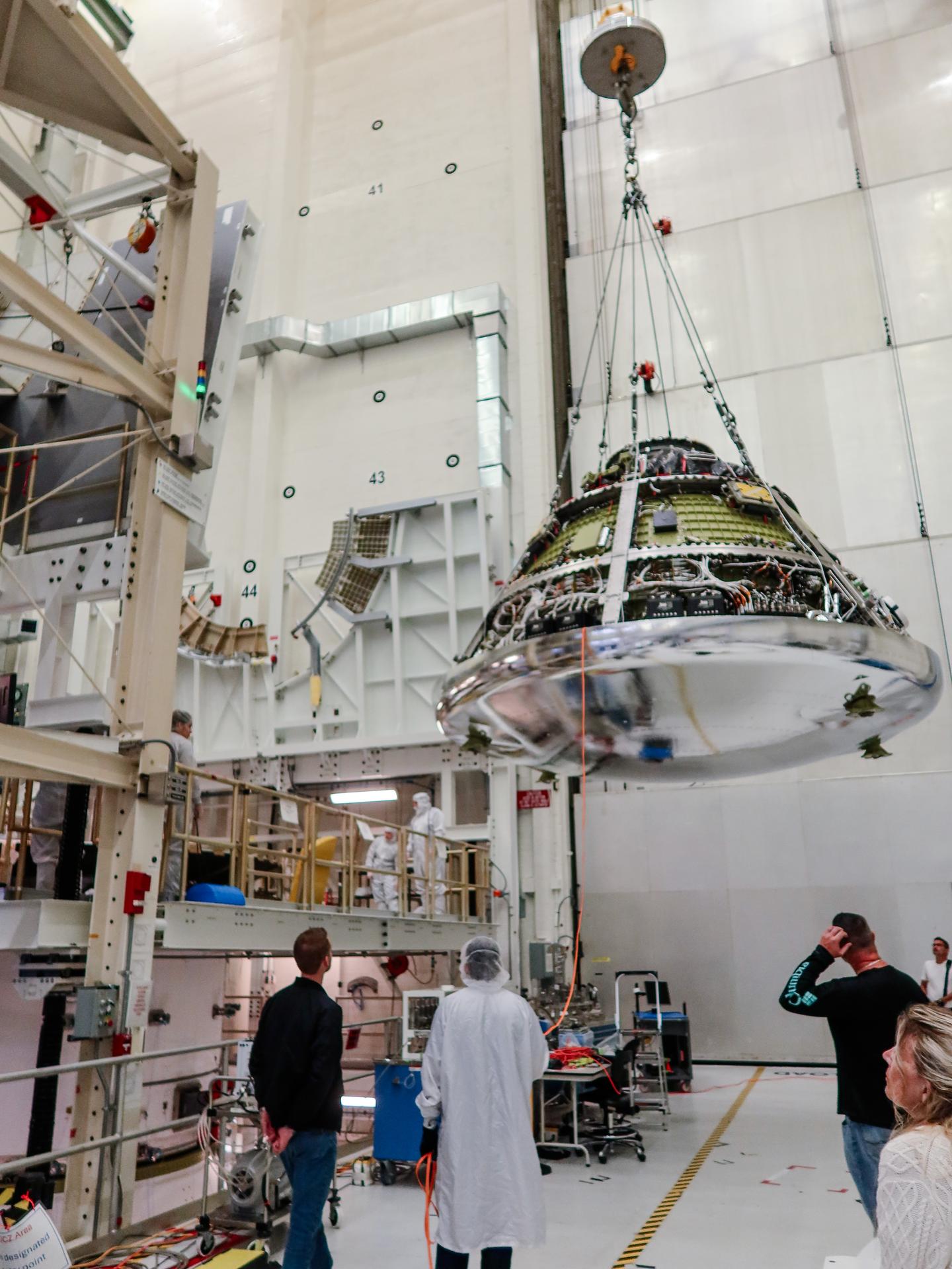 Engineers prepare to connect the Orion crew and service modules for the Artemis III mission on Thursday, July 30, 2026, inside the Neil A. Armstrong Operations and Checkout Building at NASA’s Kennedy Space Center in Florida. With the crew and service modules integrated, the team will power up the combined crew and service module for the first time then begin altitude chamber testing, which will put the spacecraft through conditions as close as possible to the environment it will experience in low Earth orbit. Artemis III and the four-person crew will carry out a series of objectives in low Earth orbit designed to demonstrate critical systems needed for future lunar landings, beginning with Artemis IV. 