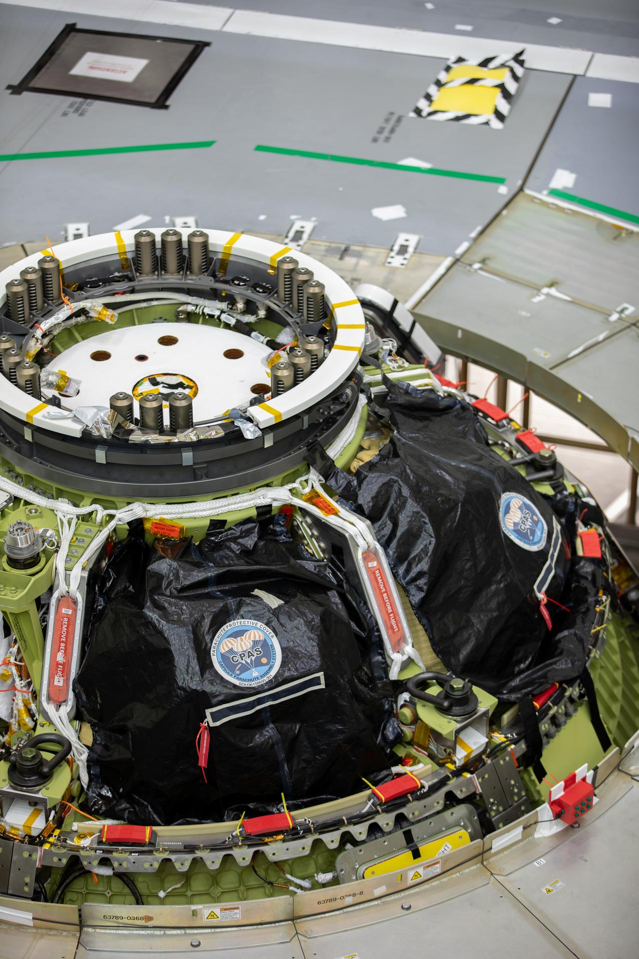 A photographer captures the top of the Artemis III Orion crew module and its parachutes after integration with the European Service Module on Friday, July 31, 2026, inside the Neil A. Armstrong Operations and Checkout Building at NASA’s Kennedy Space Center in Florida. Now integrated, the team will power up the combined crew and service module for the first time then begin altitude chamber testing, which will put the spacecraft through conditions as close as possible to the environment it will experience in low Earth orbit. Artemis III and the four-person crew will carry out a series of objectives in low Earth orbit designed to demonstrate critical systems needed for future lunar landings, beginning with Artemis IV.