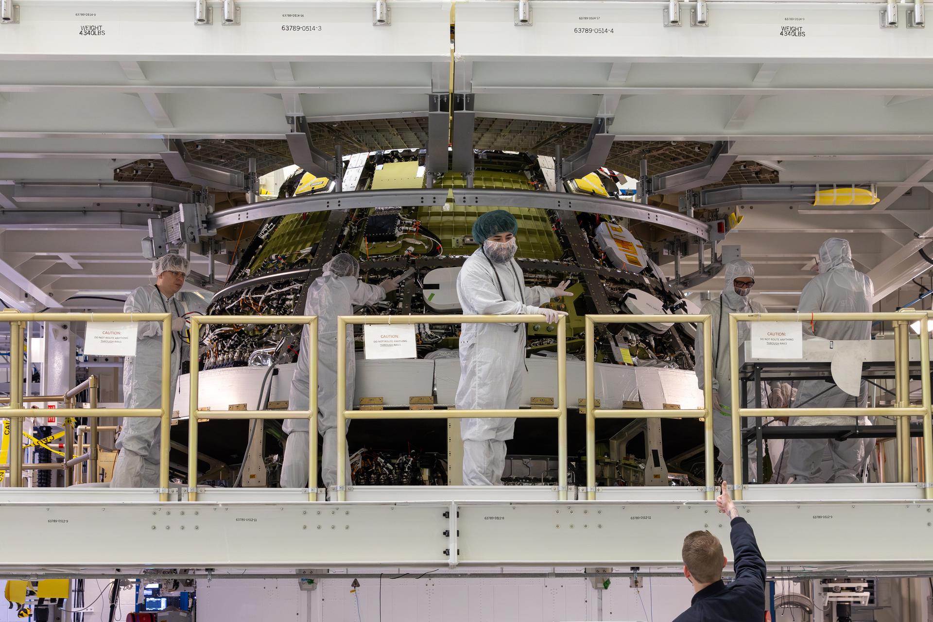 Engineers finish connecting the Artemis III Orion crew and service modules on Friday, July 31, 2026, inside the Neil A. Armstrong Operations and Checkout Building at NASA’s Kennedy Space Center in Florida. Now integrated, the team will power up the combined crew and service module for the first time then begin altitude chamber testing, which will put the spacecraft through conditions as close as possible to the environment it will experience in low Earth orbit. Artemis III and the four-person crew will carry out a series of objectives in low Earth orbit designed to demonstrate critical systems needed for future lunar landings, beginning with Artemis IV.