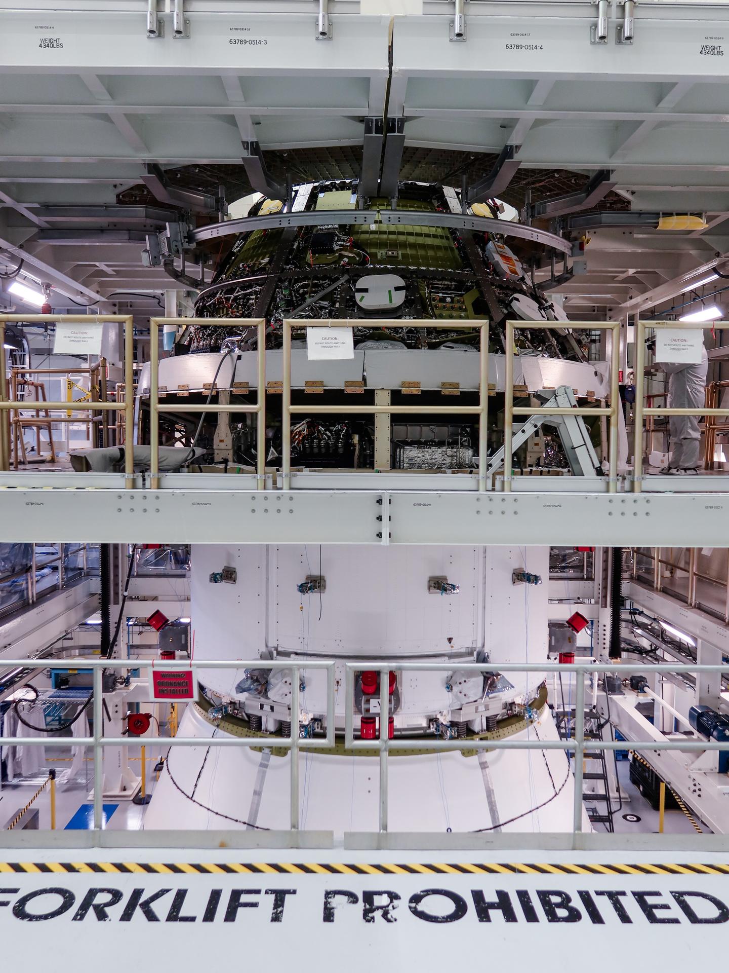 Engineers finish connecting the Artemis III Orion crew and service modules on Friday, July 31, 2026, inside the Neil A. Armstrong Operations and Checkout Building at NASA’s Kennedy Space Center in Florida. Now integrated, the team will power up the combined crew and service module for the first time then begin altitude chamber testing, which will put the spacecraft through conditions as close as possible to the environment it will experience in low Earth orbit. Artemis III and the four-person crew will carry out a series of objectives in low Earth orbit designed to demonstrate critical systems needed for future lunar landings, beginning with Artemis IV.