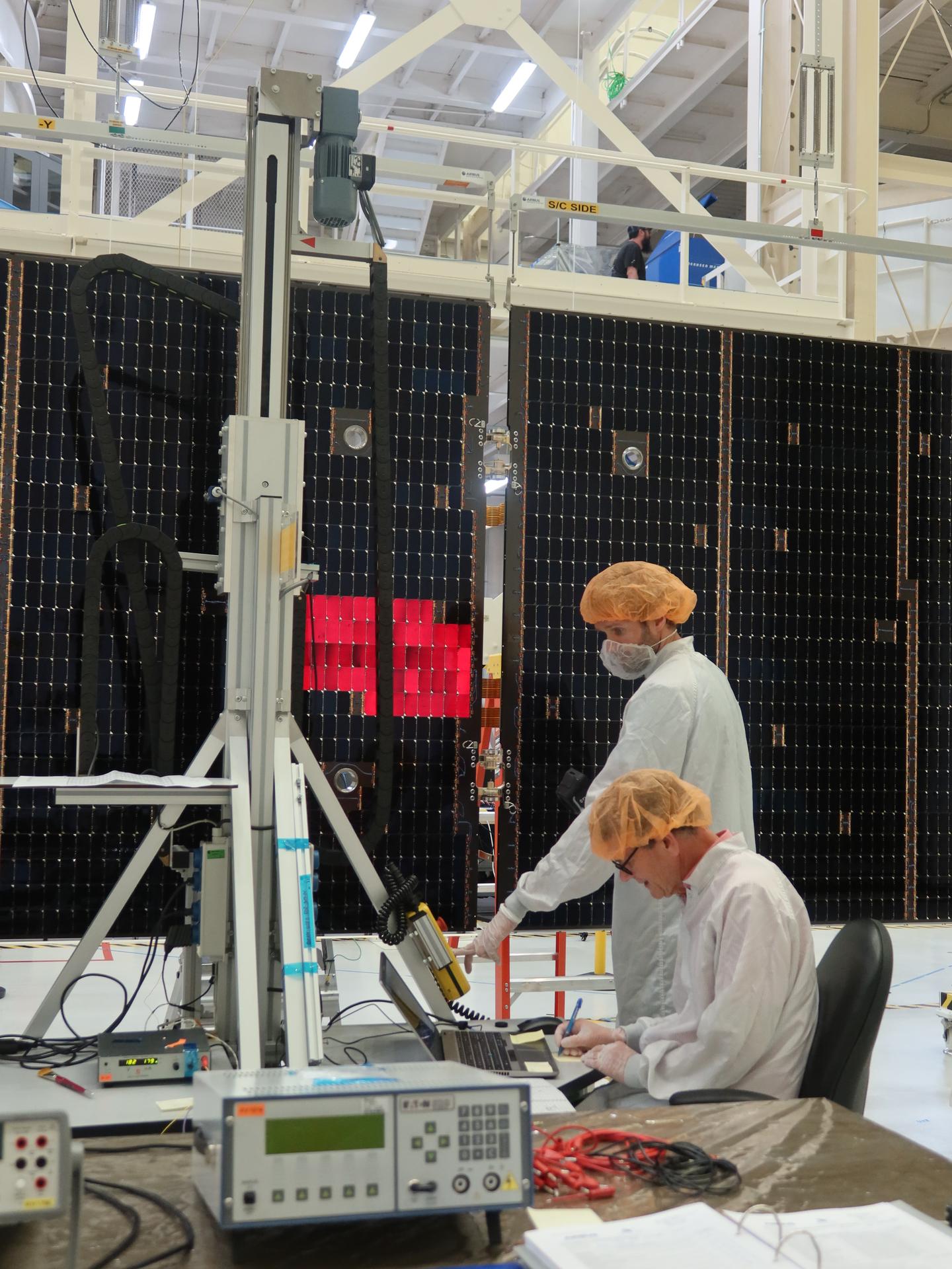 Technicians extend and inspect one of the solar array wing panels that will attach the Orion service module for Artemis III inside the Neil A. Armstrong Operations and Checkout Building high bay at NASA’s Kennedy Space Center in Florida on Tuesday, Aug. 18, 2026. Each solar array panel, provided by the European Space Agency and built by Airbus, generates 11 kilowatts of power and spans about 63 feet to supply Orion’s power, propulsion, air, and water through low Earth Orbit.
