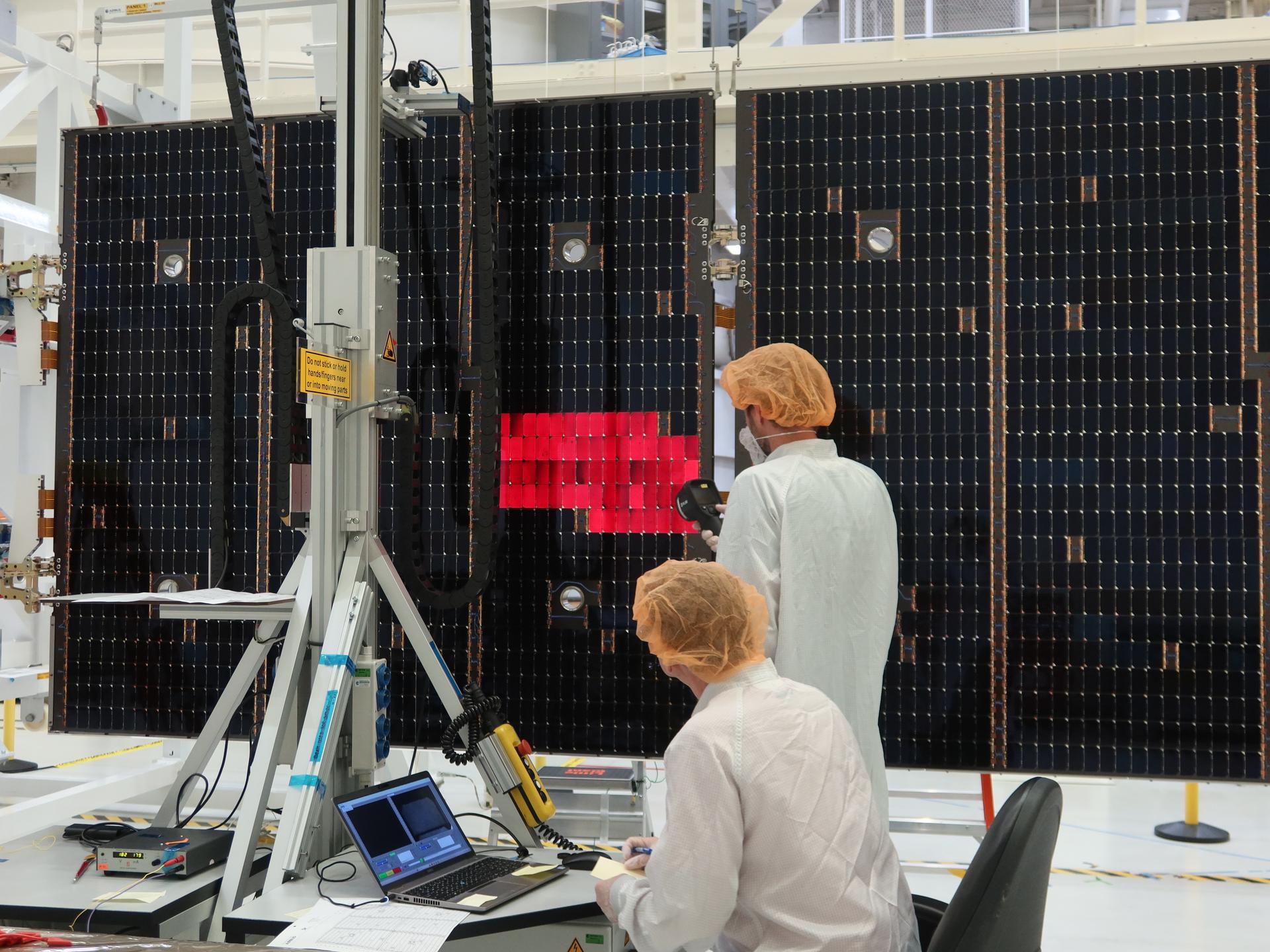 A technician is lighting one of the solar array wing panels as part of an illumination test for Artemis III inside the Neil A. Armstrong Operations and Checkout Building high bay at NASA’s Kennedy Space Center in Florida on Tuesday, Aug. 18, 2026. Technicians extended, inspected, and then retracted the four wings that will be attached to the Orion service module. Each solar array panel, provided by the European Space Agency and built by Airbus, generates 11 kilowatts of power and spans about 63 feet to supply Orion’s power, propulsion, air, and water through low Earth Orbit.
