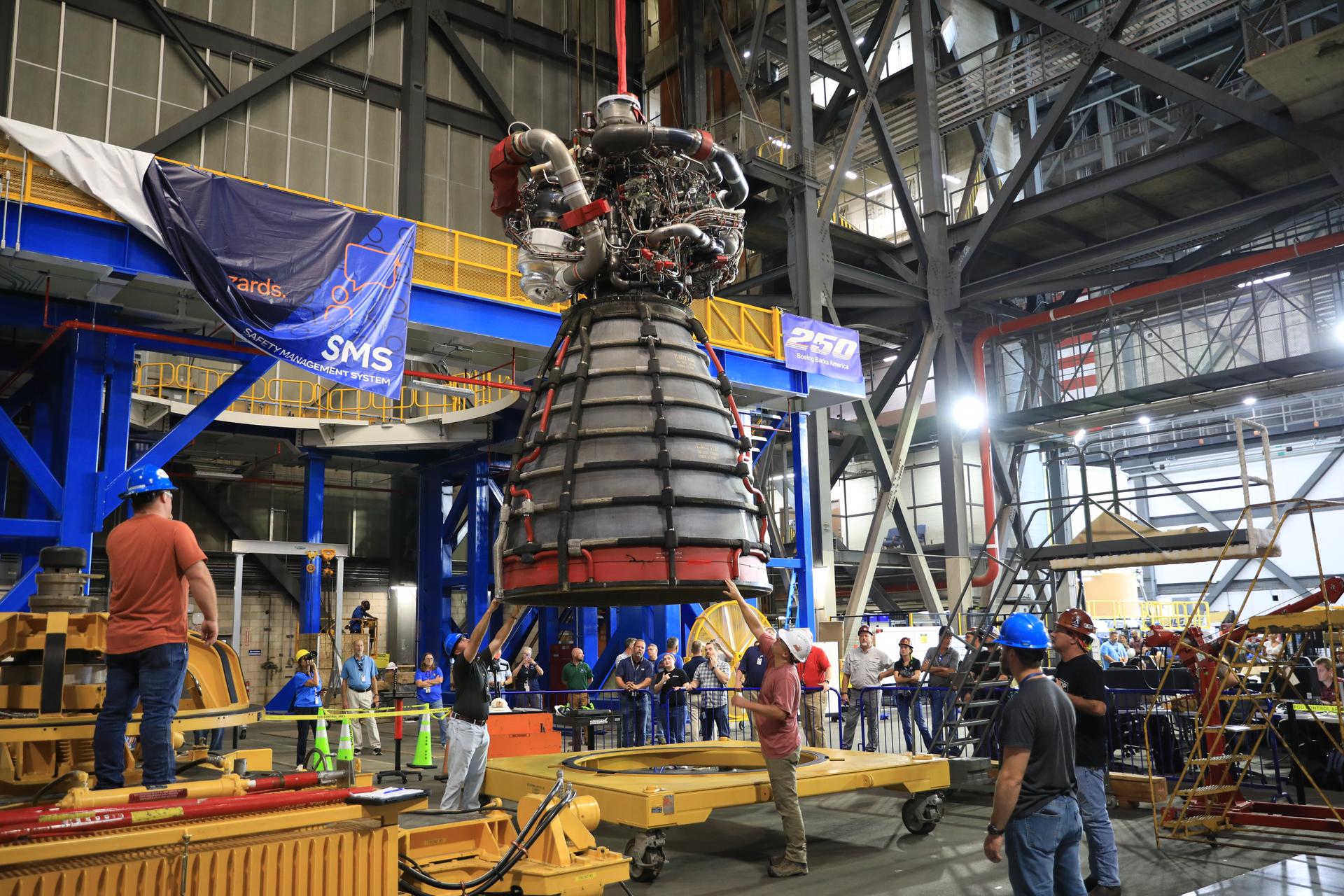 Technicians lift the #2 RS-25 SLS (Space Launch System) rocket engine to prepare to transfer the engine to the work stand to be integrated with the Artemis III core stage rocket on Tuesday, Aug. 25, 2026, inside the Vehicle Assembly Building at NASA’s Kennedy Space Center in Florida. During Artemis III four engines will propel the Orion spacecraft, carrying four astronauts, into low Earth orbit providing over two million pounds of thrust at liftoff. “During Artemis III, the four RS‑25 engines will launch the Orion spacecraft and its crew of four into low Earth orbit, generating more than two million pounds of thrust at liftoff. 
