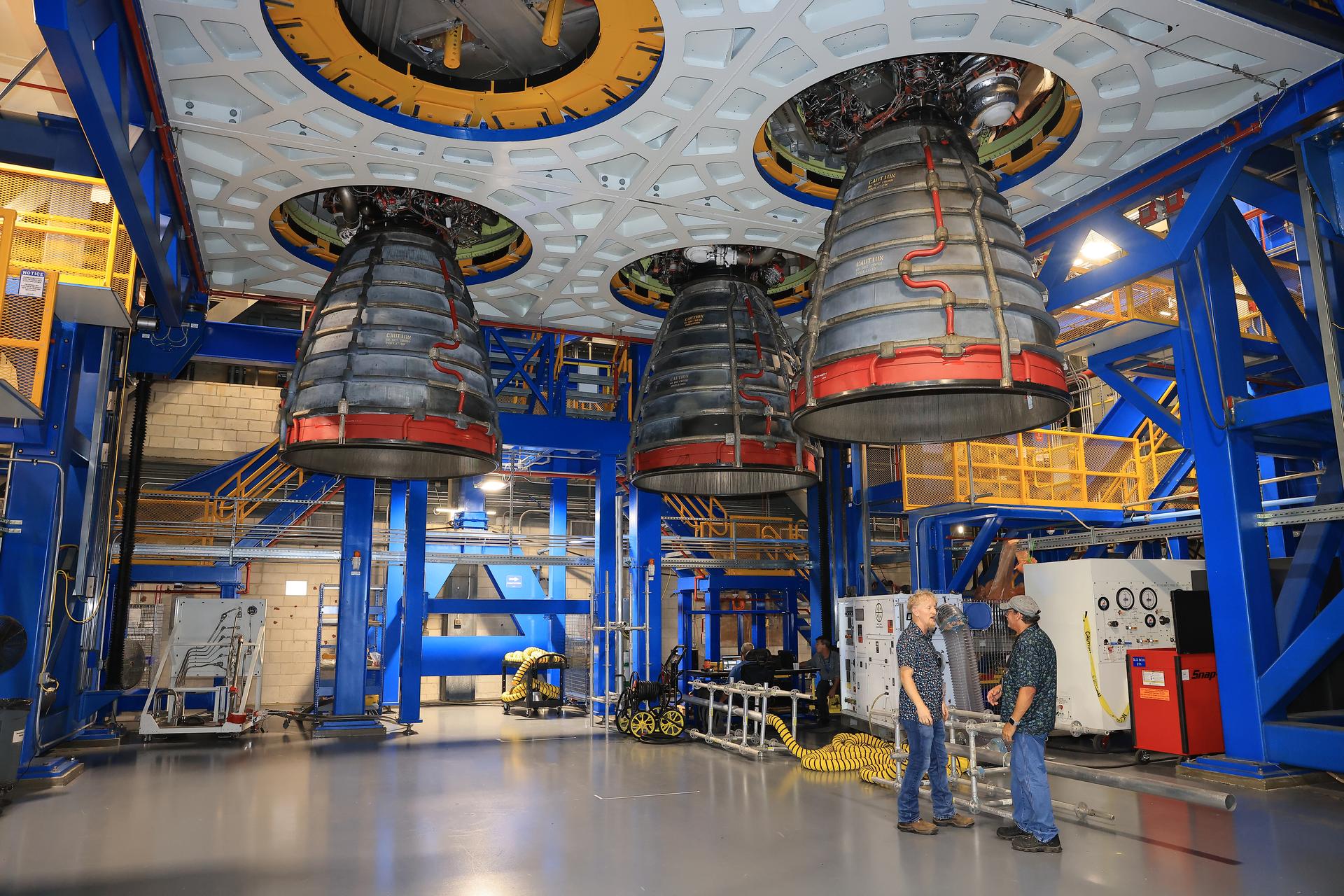 Technicians install three of four RS-25 SLS (Space Launch System) rocket engines on the work stand for integration with the Artemis III core stage rocket on Friday, Aug. 28, 2026, inside the Vehicle Assembly Building at NASA’s Kennedy Space Center in Florida. During Artemis III, the four RS-25 engines will launch the Orion spacecraft and its crew of four into low Earth orbit, generating more than two million pounds of thrust at liftoff.