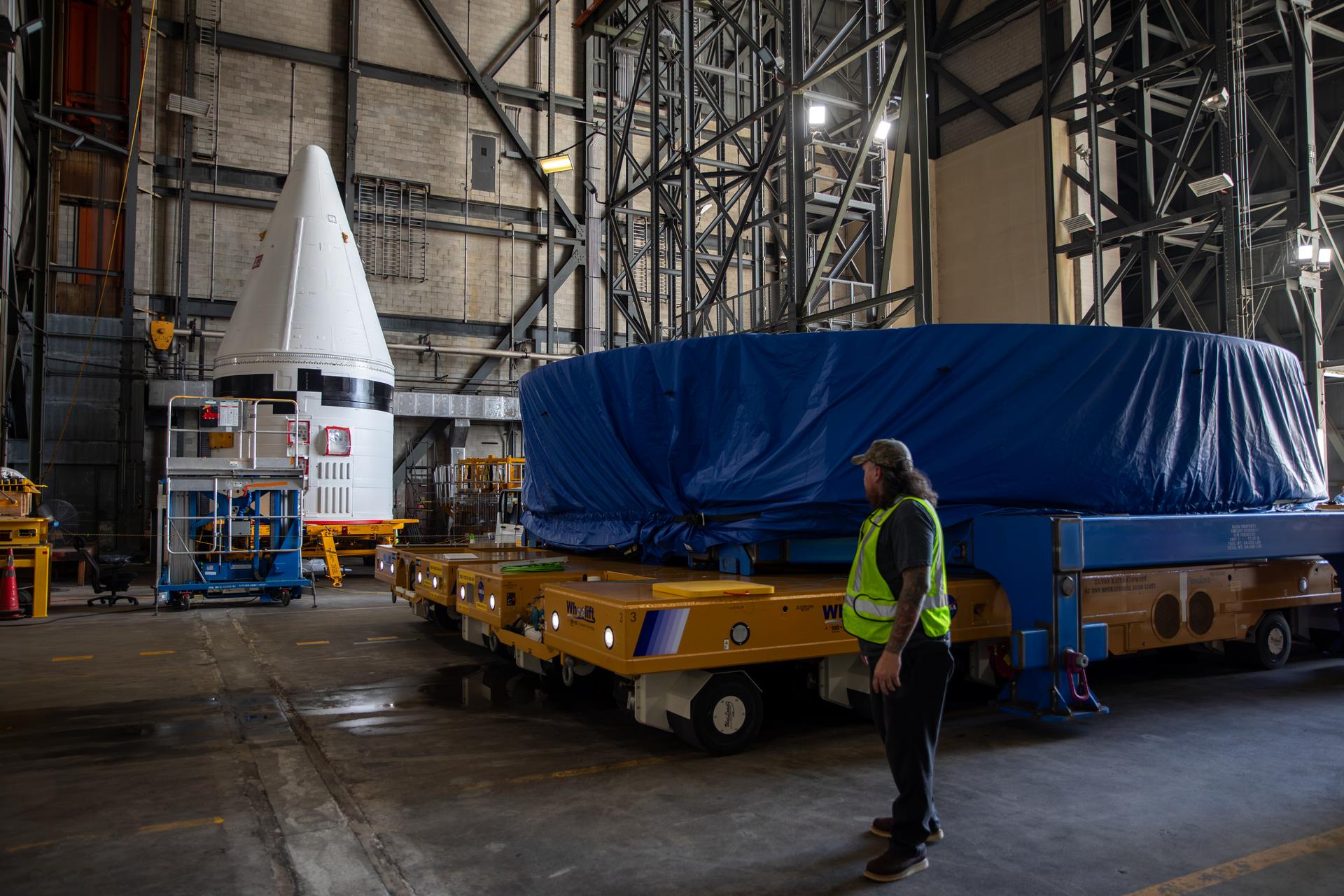 NASA’s Artemis IV SLS (Space Launch System) core stage boat-tail, covered in a protective blue tarp, arrives inside the NASA’s Vehicle Assembly Building at Kennedy Space Center in Florida on Monday, Aug. 31, 2026. Manufactured at NASA’s Michoud Assembly Facility in New Orleans, Louisiana, the boat-tail is a fairing-like structure that protects the bottom end of the SLS (Space Launch System) rocket core stage and RS-25 engines.   