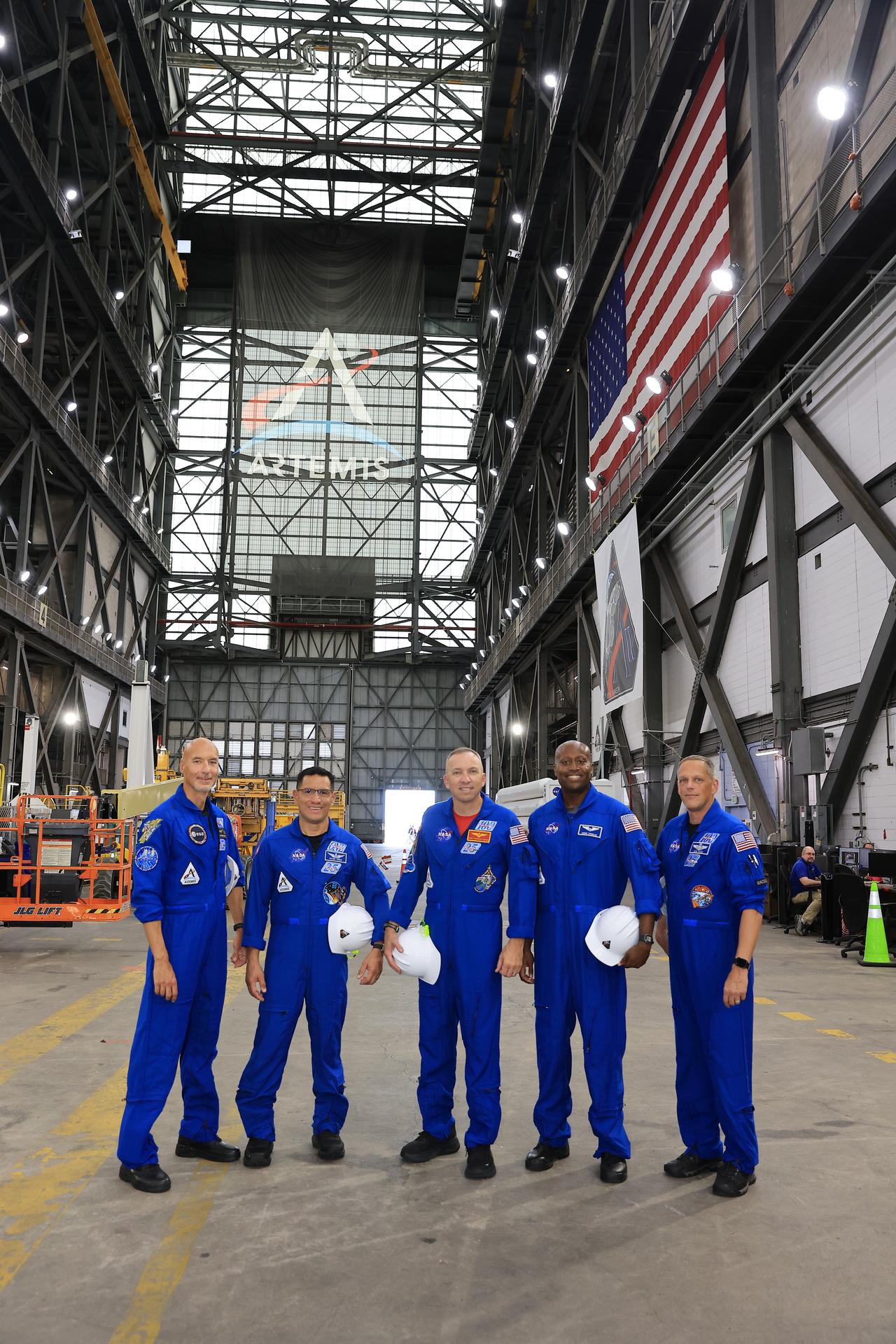 The Artemis III primary and back-up crew members pose for a photograph on Wednesday, Sept. 2, 2026, inside the Vehicle Assembly Building at NASA's Kennedy Space Center in Florida. From left, ESA (European Space Agency) astronaut Luca Parmitano, pilot; NASA astronaut Frank Rubio, mission specialist; NASA astronaut Randy Bresnik, commander; NASA astronaut Andre Douglas, mission specialist; and NASA astronaut Bob Hines, backup crew member, viewed the work progress on the Artemis III SLS (Space Launch System) rocket core stage inside High Bay 2 and the solid rocket booster integration inside High Bay 3. This marked the first visit to Kennedy by the entire crew and backup crew members. Artemis III will launch four crew members aboard the Orion spacecraft to carry out a series of objectives in low Earth orbit designed to demonstrate critical systems needed for future lunar landings, beginning with Artemis IV.