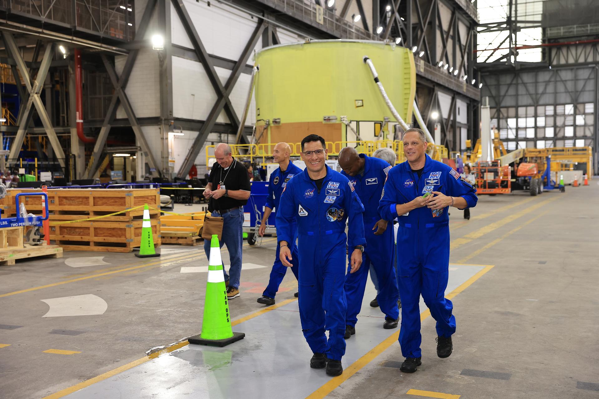 The Artemis III primary and back-up crew members walk by the core stage engine section for NASA’s Artemis IV mission in the transfer aisle of the Vehicle Assembly Building at NASA's Kennedy Space Center in Florida on Wednesday, Sept. 2, 2026. Dressed in blue flight suits, from left, ESA (European Space Agency) astronaut Luca Parmitano, and NASA astronauts Frank Rubio, Andre Douglas, and Bob Hines, along with Randy Bresnik (not pictured) viewed the work progress on the Artemis III SLS (Space Launch System) rocket core stage inside High Bay 2 and the solid rocket booster integration inside High Bay 3. This marked the first visit to Kennedy by the entire crew and backup crew members. Artemis III will launch four crew members aboard the Orion spacecraft to carry out a series of objectives in low Earth orbit designed to demonstrate critical systems needed for future lunar landings, beginning with Artemis IV.
