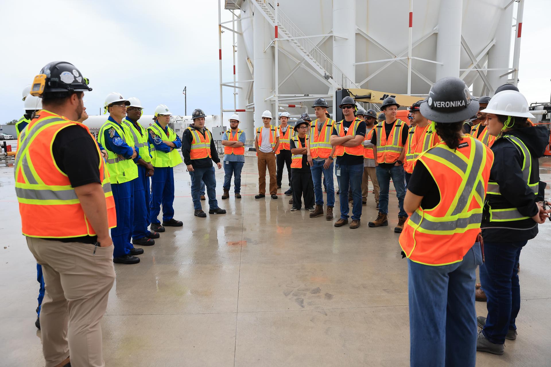 NASA’s Artemis III crew visits Launch Complex 39A at Kennedy Space Center in Florida on Thursday, Sept. 3, 2026, and speaks with members of SpaceX’s pad support team. Wearing hard hats and reflective vests over their blue flight suits, from left, NASA astronauts Frank Rubio, Bob Hines, Andre Douglas, ESA (European Space Agency) astronaut Luca Parmitano, and NASA astronaut Randy Bresnik visited facilities around Kennedy and viewed progress on Artemis III hardware and ground systems. This marked the first visit to Kennedy by the entire crew and backup crew members. Artemis III will launch four crew members aboard the Orion spacecraft to carry out a series of objectives in low Earth orbit designed to demonstrate critical systems needed for future lunar landings, beginning with Artemis IV.