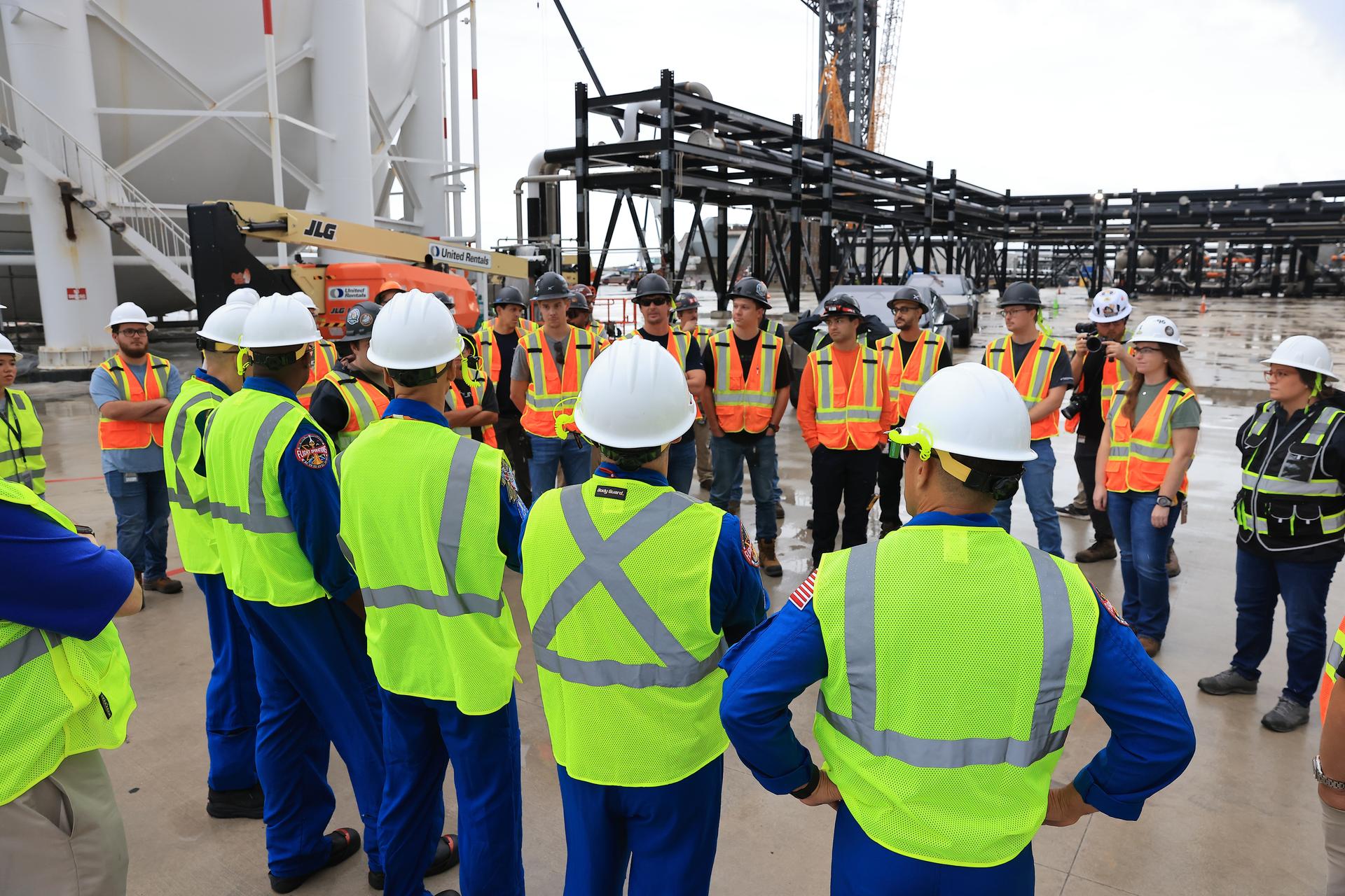 NASA’s Artemis III crew visits Launch Complex 39A at Kennedy Space Center in Florida on Thursday, Sept. 3, 2026, and speaks with members of SpaceX’s pad support team. Wearing hard hats and reflective vests over their blue flight suits, from right, NASA astronauts Frank Rubio, Bob Hines, Andre Douglas, ESA (European Space Agency) astronaut Luca Parmitano, and NASA astronaut Randy Bresnik visited facilities around Kennedy and viewed progress on Artemis III hardware and ground systems. This marked the first visit to Kennedy by the entire crew and backup crew members. Artemis III will launch four crew members aboard the Orion spacecraft to carry out a series of objectives in low Earth orbit designed to demonstrate critical systems needed for future lunar landings, beginning with Artemis IV.