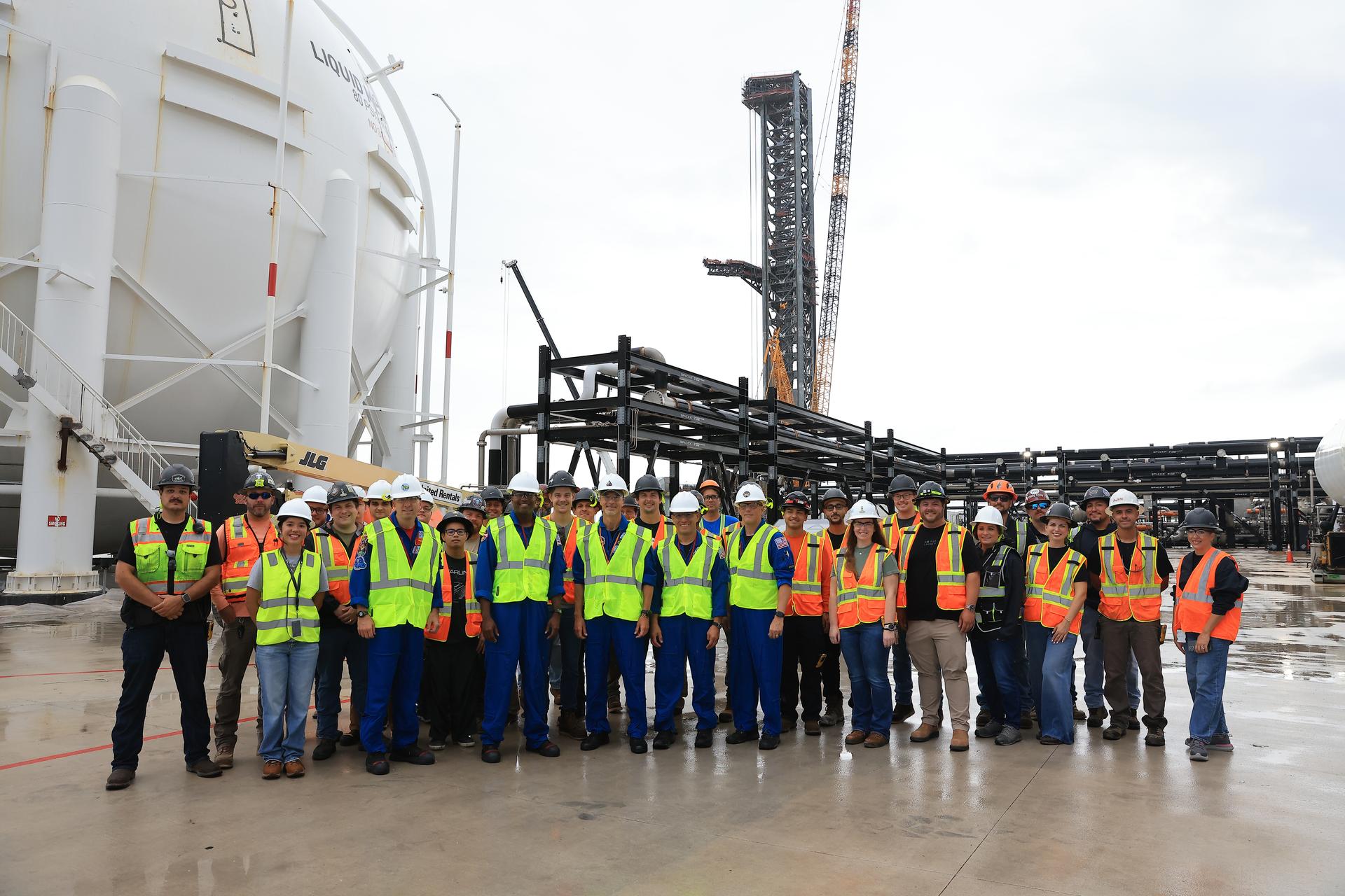 NASA’s Artemis III crew poses with members of SpaceX’s pad support team at Launch Complex 39A at Kennedy Space Center in Florida on Thursday, Sept. 3, 2026. Wearing hard hats and reflective vests over their blue flight suits, from left, NASA astronauts Randy Bresnik, Andre Douglas, ESA (European Space Agency) astronaut Luca Parmitano, and NASA astronauts Frank Rubio and Bob Hines visited facilities around Kennedy and viewed progress on Artemis III hardware and ground systems. This marked the first visit to Kennedy by the entire crew and backup crew members. Artemis III will launch four crew members aboard the Orion spacecraft to carry out a series of objectives in low Earth orbit designed to demonstrate critical systems needed for future lunar landings, beginning with Artemis IV.