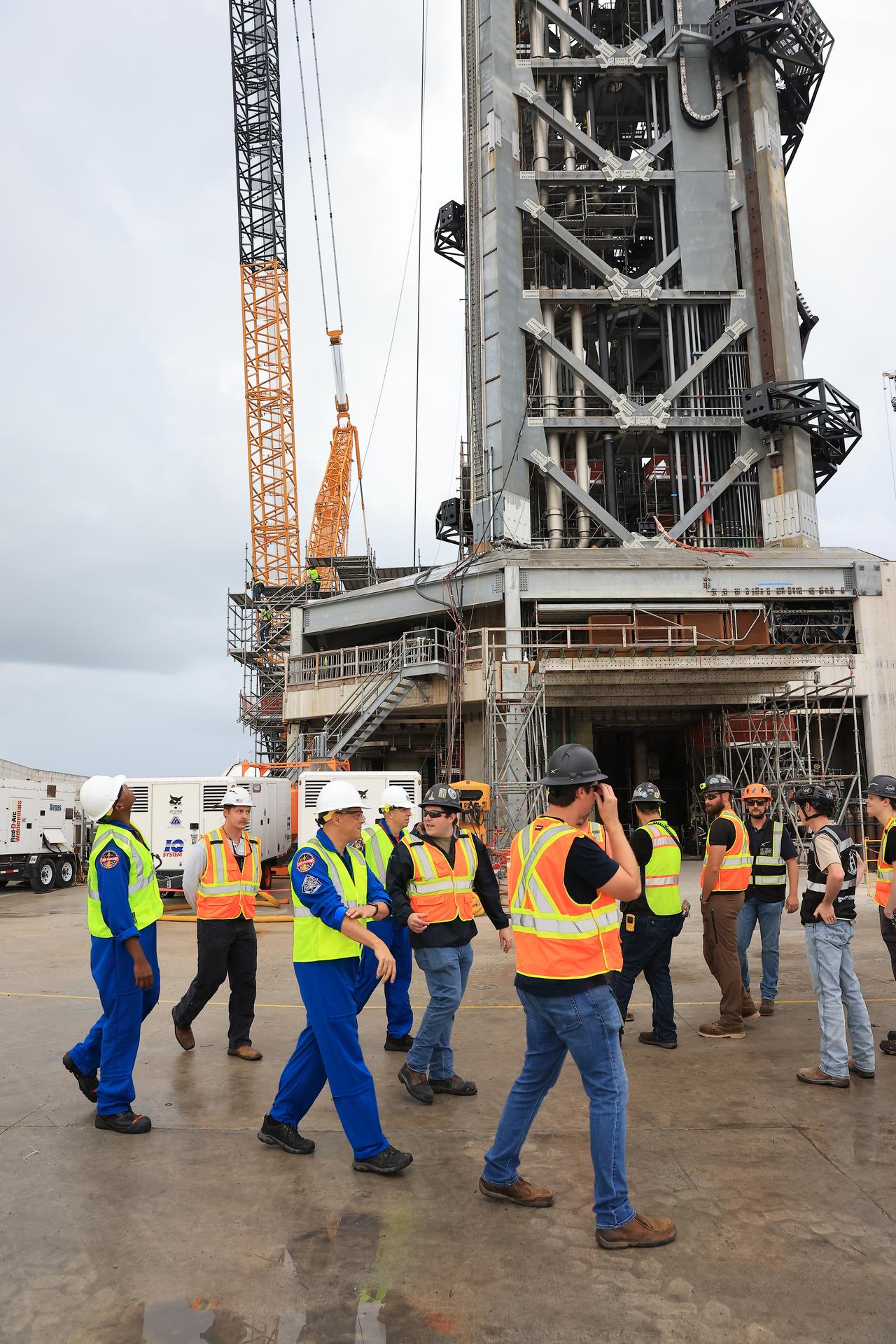 NASA’s Artemis III crew visits Launch Complex 39A at Kennedy Space Center in Florida on Thursday, Sept. 3, 2026, and speaks with members of SpaceX’s pad support team. Wearing hard hats and reflective vests over their blue flight suits, from left, NASA astronauts Andre Douglas, Bob Hines, and Randy Bresnik, along with NASA astronaut Frank Rubio (not picture) and ESA (European Space Agency) astronaut Luca Parmitano (not pictured), visited facilities around Kennedy and viewed progress on Artemis III hardware and ground systems. This marked the first visit to Kennedy by the entire crew and backup crew members. Artemis III will launch four crew members aboard the Orion spacecraft to carry out a series of objectives in low Earth orbit designed to demonstrate critical systems needed for future lunar landings, beginning with Artemis IV.