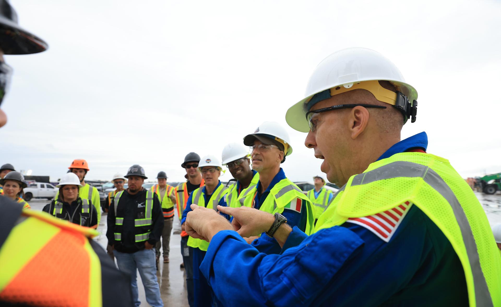 NASA’s Artemis III crew visits Launch Complex 39A at Kennedy Space Center in Florida on Thursday, Sept. 3, 2026, and speaks with members of SpaceX’s pad support team. Wearing hard hats and reflective vests over their blue flight suits, from right, NASA astronaut Randy Bresnik, ESA (European Space Agency) astronaut Luca Parmitano, and NASA astronauts Andre Douglas and Bob Hines, along with NASA astronaut Frank Rubio (not pictured) visited facilities around Kennedy and viewed progress on Artemis III hardware and ground systems. This marked the first visit to Kennedy by the entire crew and backup crew members. Artemis III will launch four crew members aboard the Orion spacecraft to carry out a series of objectives in low Earth orbit designed to demonstrate critical systems needed for future lunar landings, beginning with Artemis IV.