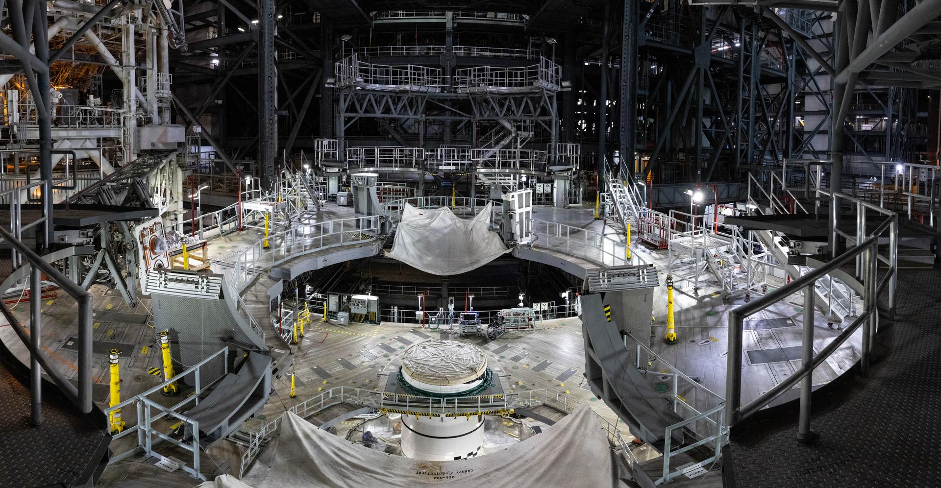 In High Bay 3 of the Vehicle Assembly Building at NASA’s Kennedy Space Center in Florida, the right forward center booster for Artemis III is integrated onto the right booster segments on the mobile launcher for the SLS (Space Launch System) rocket on Friday, Sept. 11, 2026. The twin boosters, comprising of five segments each manufactured by Northrop Grumman in Utah, will provide more than 75 percent of the SLS rocket’s total thrust at launch. The Artemis III mission will launch crew in the Orion spacecraft on top of the SLS rocket to test rendezvous and docking capabilities between Orion and commercial spacecraft needed to land astronauts on the Moon. 