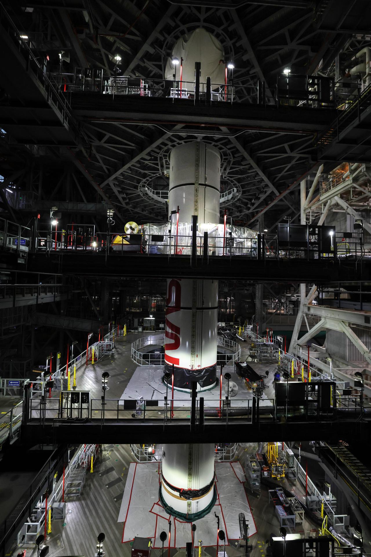 In High Bay 3 of the Vehicle Assembly Building at NASA’s Kennedy Space Center in Florida, the right forward center booster for Artemis III is integrated onto the right booster segments on the mobile launcher for the SLS (Space Launch System) rocket on Friday, Sept. 11, 2026. The twin boosters, comprising of five segments each manufactured by Northrop Grumman in Utah, will provide more than 75 percent of the SLS rocket’s total thrust at launch. The Artemis III mission will launch crew in the Orion spacecraft on top of the SLS rocket to test rendezvous and docking capabilities between Orion and commercial spacecraft needed to land astronauts on the Moon. 