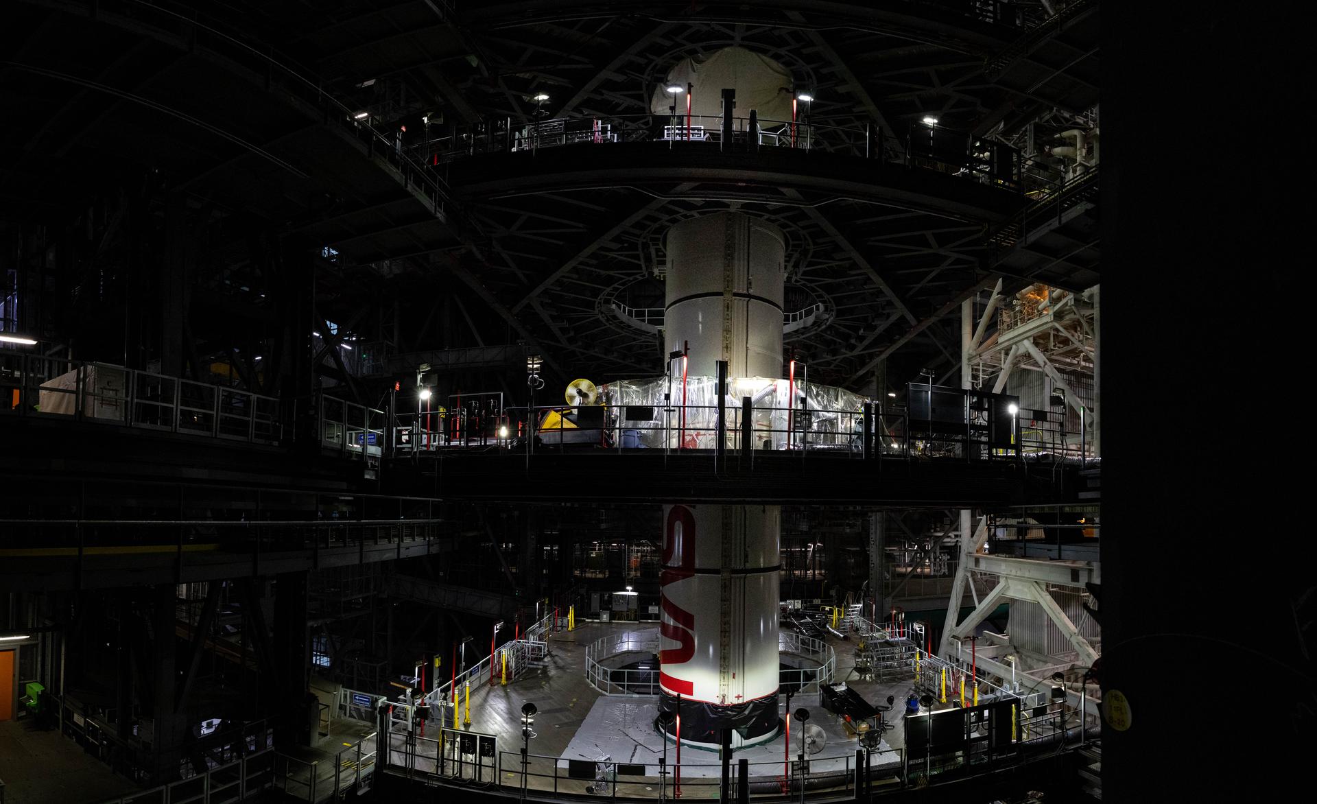 In High Bay 3 of the Vehicle Assembly Building at NASA’s Kennedy Space Center in Florida, the right forward center booster for Artemis III is integrated onto the right booster segments on the mobile launcher for the SLS (Space Launch System) rocket on Friday, Sept. 11, 2026. The twin boosters, comprising of five segments each manufactured by Northrop Grumman in Utah, will provide more than 75 percent of the SLS rocket’s total thrust at launch. The Artemis III mission will launch crew in the Orion spacecraft on top of the SLS rocket to test rendezvous and docking capabilities between Orion and commercial spacecraft needed to land astronauts on the Moon. 