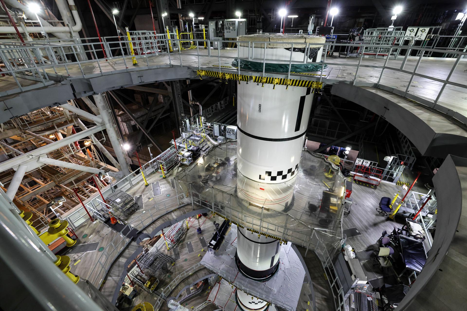 In High Bay 3 of the Vehicle Assembly Building at NASA’s Kennedy Space Center in Florida, the right forward center booster for Artemis III is integrated onto the right booster segments on the mobile launcher for the SLS (Space Launch System) rocket on Friday, Sept. 11, 2026. The twin boosters, comprising of five segments each manufactured by Northrop Grumman in Utah, will provide more than 75 percent of the SLS rocket’s total thrust at launch. The Artemis III mission will launch crew in the Orion spacecraft on top of the SLS rocket to test rendezvous and docking capabilities between Orion and commercial spacecraft needed to land astronauts on the Moon. 