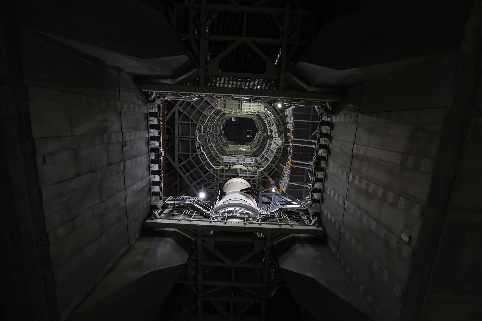 In High Bay 3 of the Vehicle Assembly Building at NASA’s Kennedy Space Center in Florida, portions of the solid rocket booster right forward center booster for Artemis III is integrated onto the right booster segments on the mobile launcher for the SLS (Space Launch System) rocket on Friday, Sept. 11, 2026. The twin boosters, comprising of five segments each manufactured by Northrop Grumman in Utah, will provide more than 75 percent of the SLS rocket’s total thrust at launch. The Artemis III mission will launch crew in the Orion spacecraft on top of the SLS rocket to test rendezvous and docking capabilities between Orion and commercial spacecraft needed to land astronauts on the Moon. 