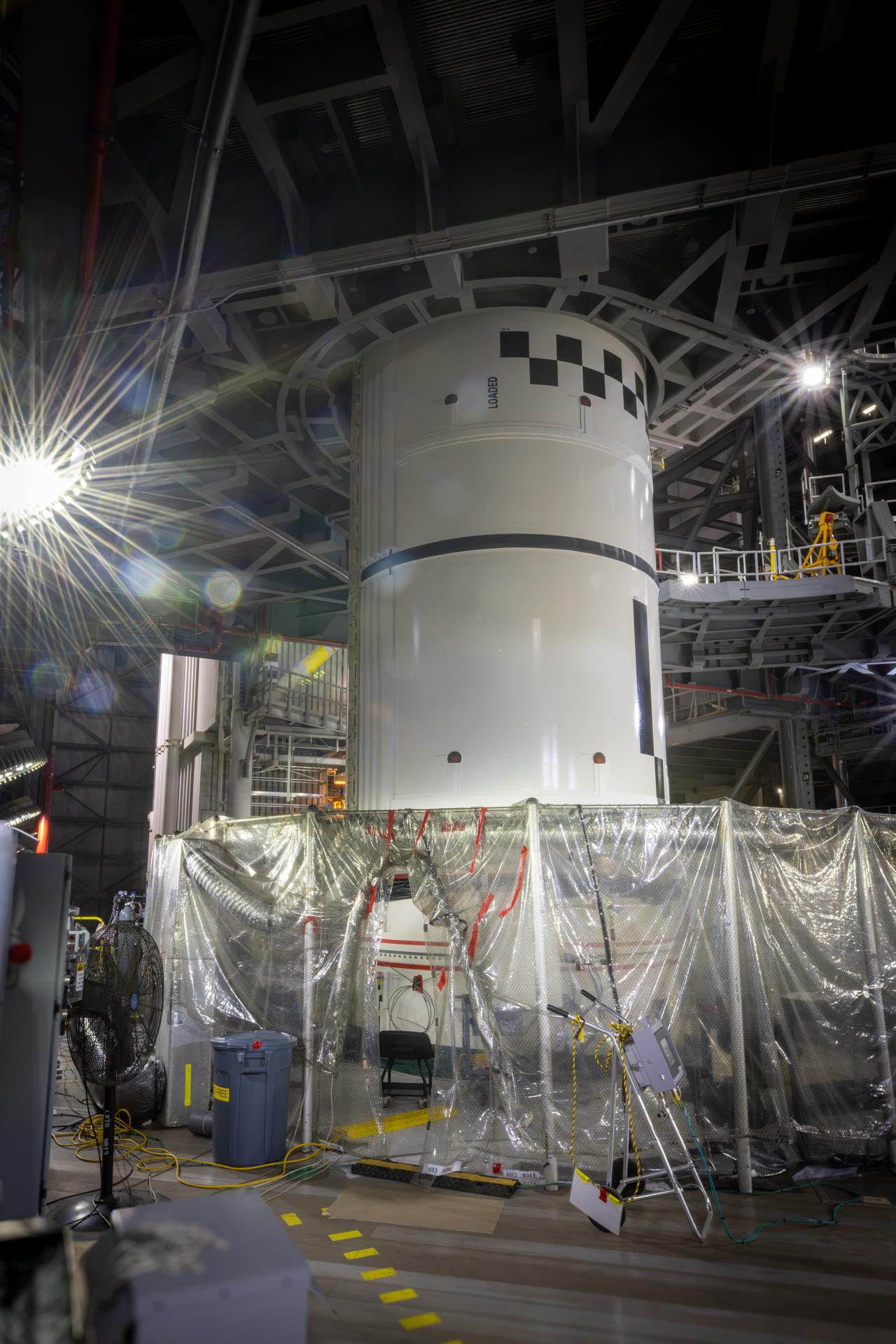 Technicians integrate the left forward booster segment for NASA’s Artemis III SLS (Space Launch System) rocket onto the left booster segments atop the mobile launcher in High Bay 3 of the Vehicle Assembly Building at NASA’s Kennedy Space Center in Florida on Thursday, Sept. 17, 2026. The SLS rocket’s twin boosters, each made up of five segments manufactured by Northrop Grumman in Utah, will provide more than 75 percent of the rocket’s total thrust at launch. The Artemis III mission will launch crew in the Orion spacecraft on top of the SLS rocket to test rendezvous and docking capabilities between Orion and commercial spacecraft needed to land astronauts on the Moon.