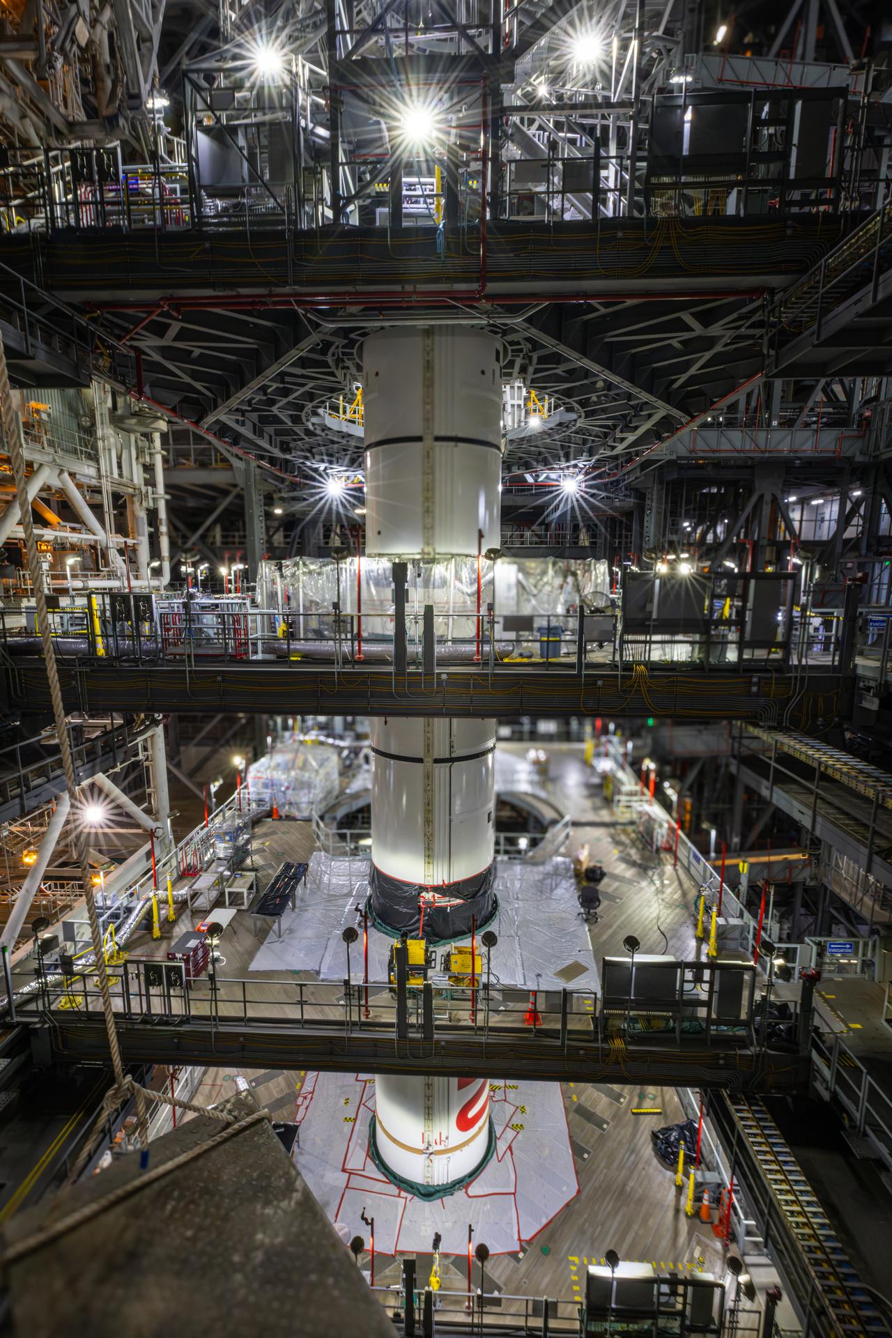 Technicians integrate the left forward booster segment for NASA’s Artemis III SLS (Space Launch System) rocket onto the left booster segments atop the mobile launcher in High Bay 3 of the Vehicle Assembly Building at NASA’s Kennedy Space Center in Florida on Thursday, Sept. 17, 2026. The SLS rocket’s twin boosters, each made up of five segments manufactured by Northrop Grumman in Utah, will provide more than 75 percent of the rocket’s total thrust at launch. The Artemis III mission will launch crew in the Orion spacecraft on top of the SLS rocket to test rendezvous and docking capabilities between Orion and commercial spacecraft needed to land astronauts on the Moon.