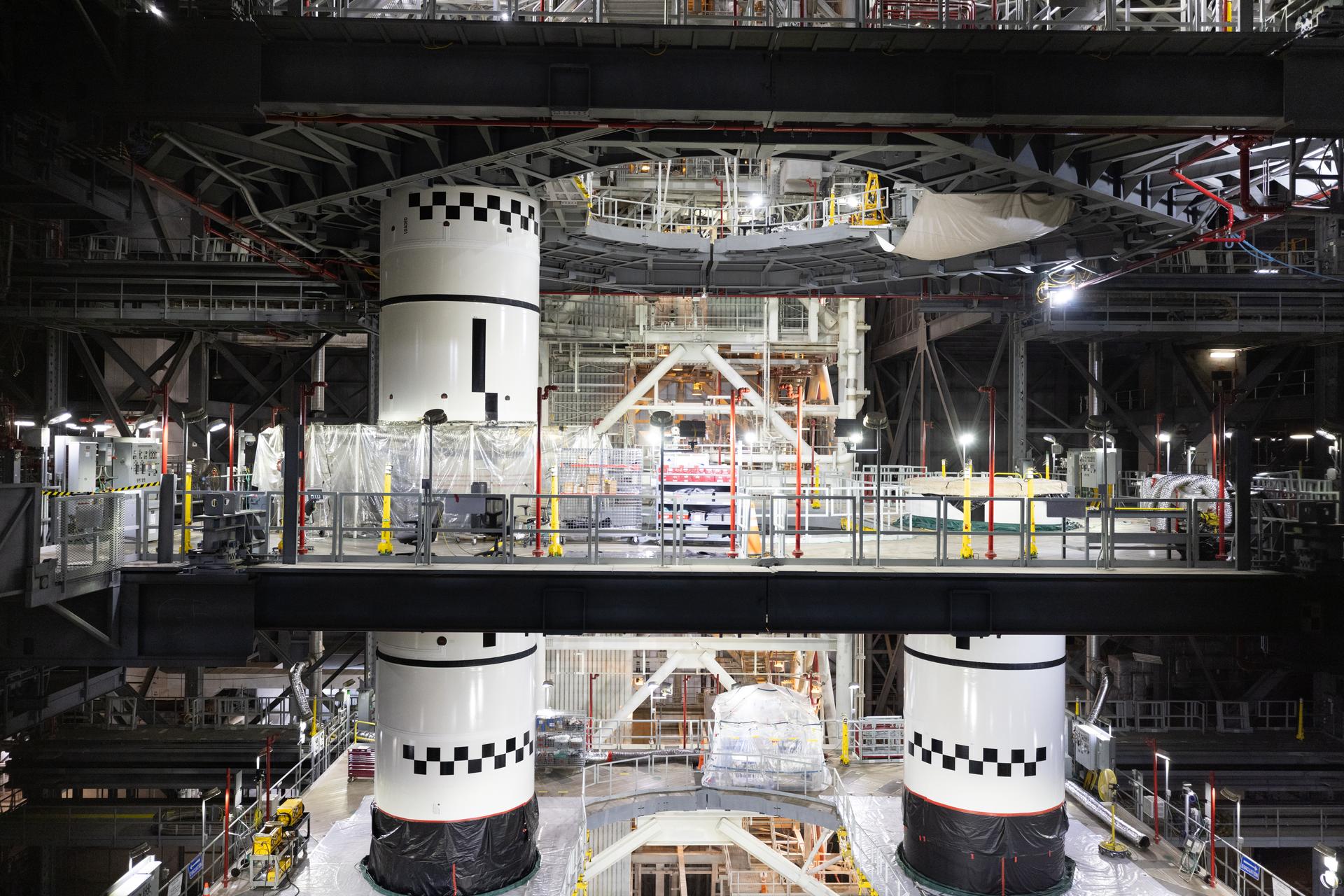 Technicians integrate the left forward booster segment for NASA’s Artemis III SLS (Space Launch System) rocket onto the left booster segments atop the mobile launcher in High Bay 3 of the Vehicle Assembly Building at NASA’s Kennedy Space Center in Florida on Thursday, Sept. 17, 2026. The SLS rocket’s twin boosters, each made up of five segments manufactured by Northrop Grumman in Utah, will provide more than 75 percent of the rocket’s total thrust at launch. The Artemis III mission will launch crew in the Orion spacecraft on top of the SLS rocket to test rendezvous and docking capabilities between Orion and commercial spacecraft needed to land astronauts on the Moon.