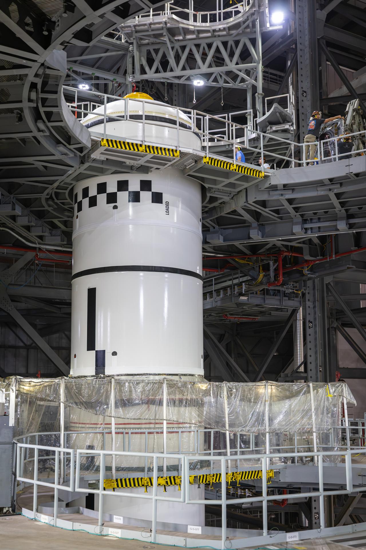 Technicians integrate the left forward booster segment for NASA’s Artemis III SLS (Space Launch System) rocket onto the left booster segments atop the mobile launcher in High Bay 3 of the Vehicle Assembly Building at NASA’s Kennedy Space Center in Florida on Thursday, Sept. 17, 2026. The SLS rocket’s twin boosters, each made up of five segments manufactured by Northrop Grumman in Utah, will provide more than 75 percent of the rocket’s total thrust at launch. The Artemis III mission will launch crew in the Orion spacecraft on top of the SLS rocket to test rendezvous and docking capabilities between Orion and commercial spacecraft needed to land astronauts on the Moon.