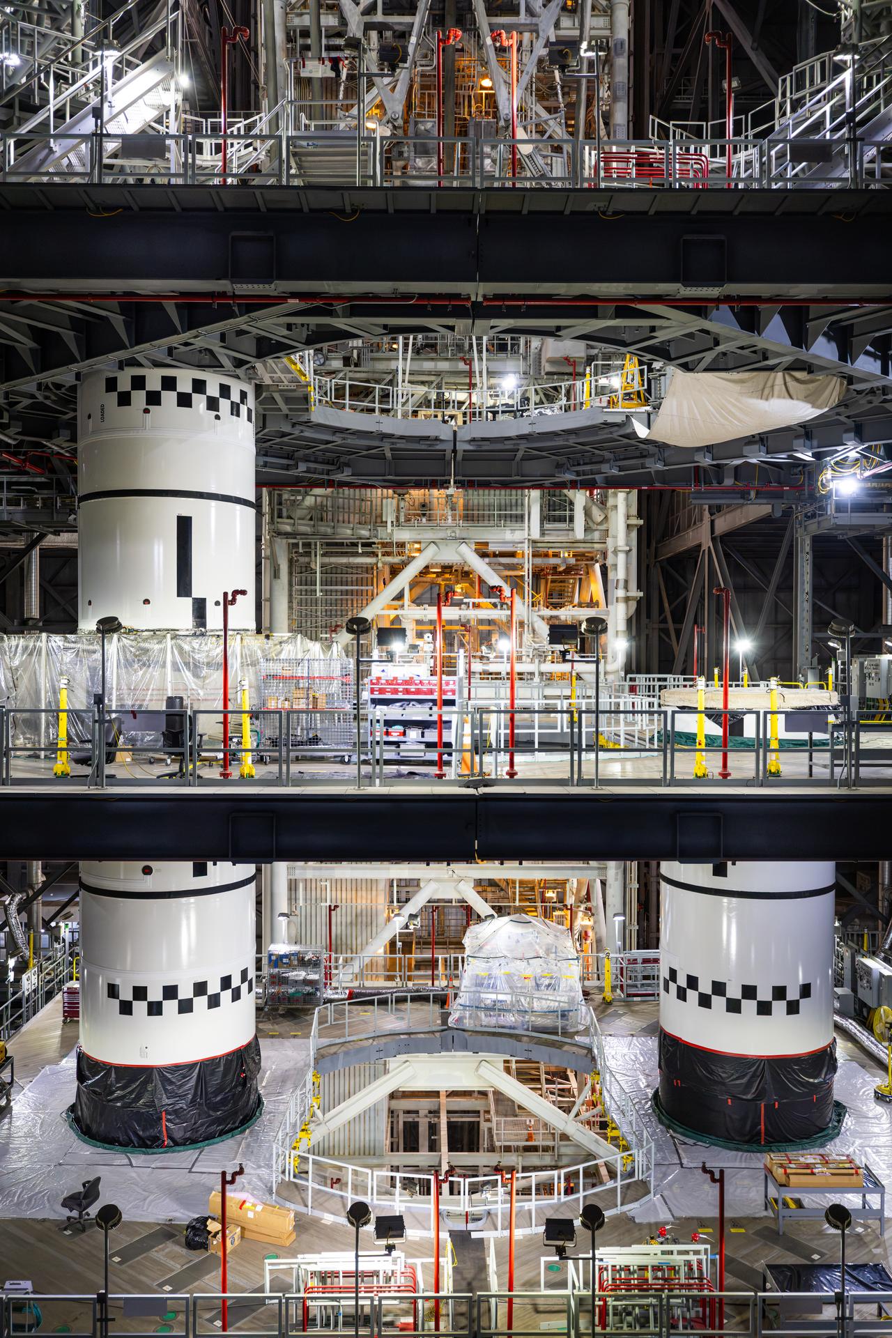 Technicians integrate the left forward booster segment for NASA’s Artemis III SLS (Space Launch System) rocket onto the left booster segments atop the mobile launcher in High Bay 3 of the Vehicle Assembly Building at NASA’s Kennedy Space Center in Florida on Thursday, Sept. 17, 2026. The SLS rocket’s twin boosters, each made up of five segments manufactured by Northrop Grumman in Utah, will provide more than 75 percent of the rocket’s total thrust at launch. The Artemis III mission will launch crew in the Orion spacecraft on top of the SLS rocket to test rendezvous and docking capabilities between Orion and commercial spacecraft needed to land astronauts on the Moon.