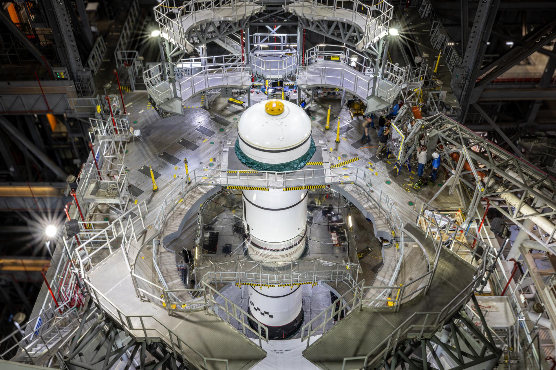 Technicians integrate the left forward booster segment for NASA’s Artemis III SLS (Space Launch System) rocket onto the left booster segments atop the mobile launcher in High Bay 3 of the Vehicle Assembly Building at NASA’s Kennedy Space Center in Florida on Thursday, Sept. 17, 2026. The SLS rocket’s twin boosters, each made up of five segments manufactured by Northrop Grumman in Utah, will provide more than 75 percent of the rocket’s total thrust at launch. The Artemis III mission will launch crew in the Orion spacecraft on top of the SLS rocket to test rendezvous and docking capabilities between Orion and commercial spacecraft needed to land astronauts on the Moon.