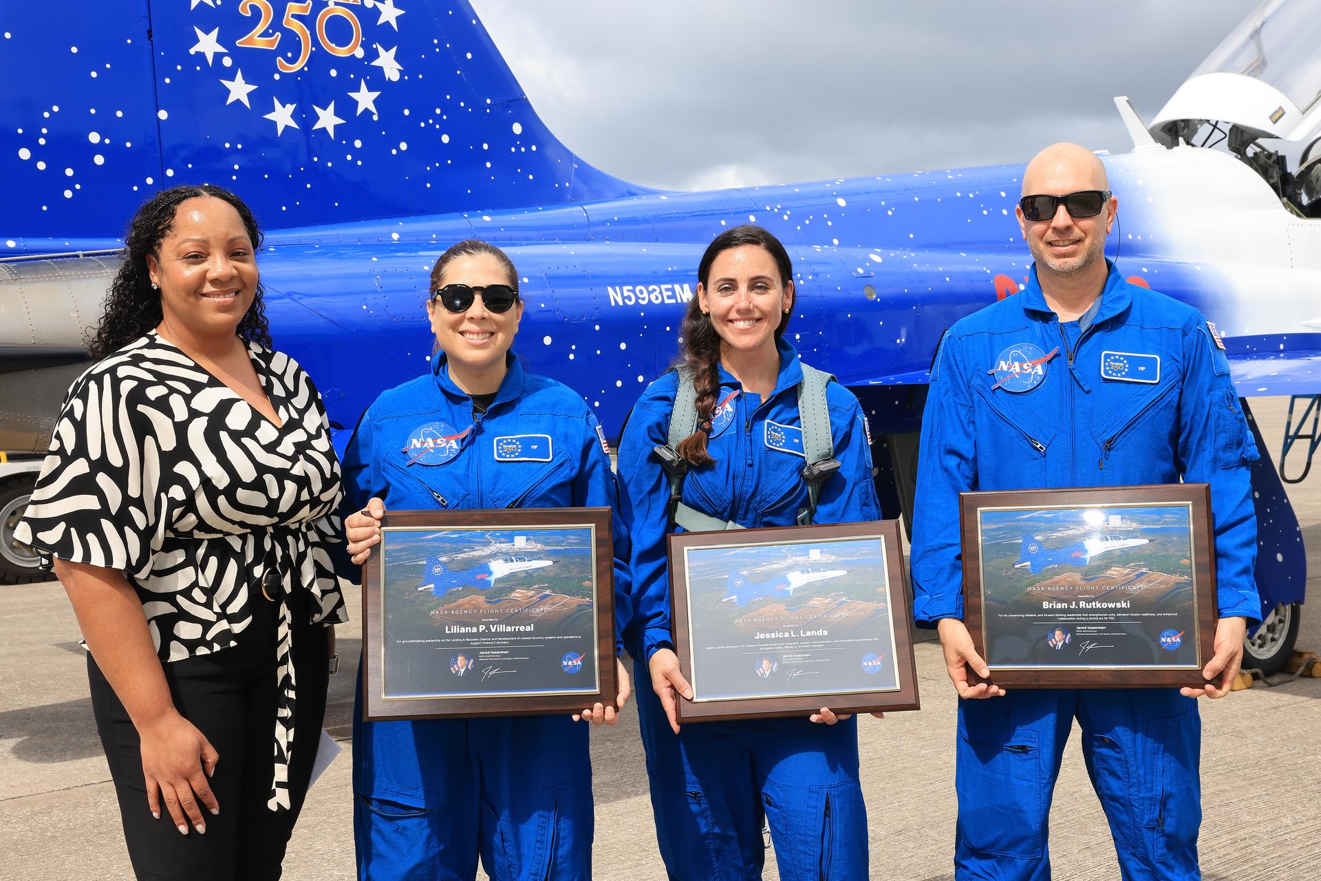 From left, Toni Gardner, Kennedy Space Center Deputy Director of Human Capital Office, along with NASA employees Lilianna Villarreal, Jessica Landa, and Brian Rutkowski pose for a photograph after participating in an employee incentive flying event using NASA Administrator Jared Isaacman's personal F-5 aircraft, Friday, Sept. 18, 2026, at NASA’s Kennedy Space Center in Florida. As part of the agency’s Flight Experience Award program, the employees donned NASA flight suits, completed preflight briefings, and experienced a unique flight. The ride-along flight experience award program highlights NASA’s commitment to celebrating excellence across the workforce.