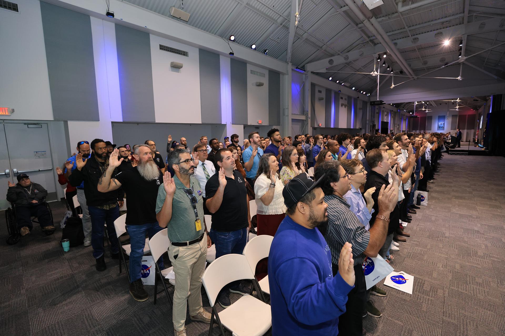 NASA’s newest civil servants participate in a swearing-in ceremony on Monday, Sept. 21, 2026, inside the Astronauts Memorial Foundation’s Center for Space Education at the Kennedy Space Center Visitor Complex in Florida. The ceremony featured the swearing-in of employees formerly from the Consolidated Operations, Management, Engineering, and Test (COMET) contract, as well as outside hires, as part of the administrator’s workforce directive to restore technical core competencies within the civil servants ranks.