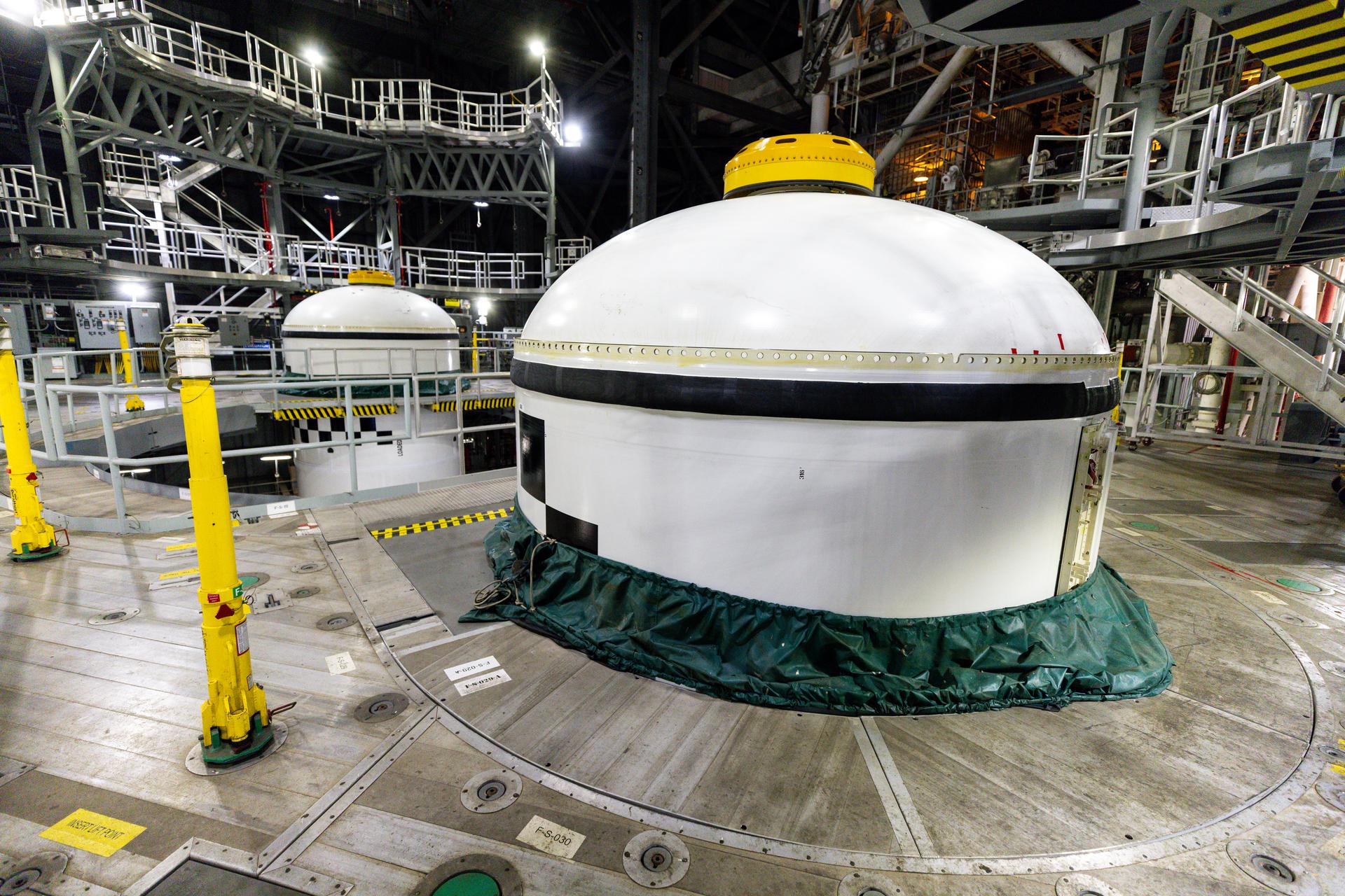In High Bay 3 of the Vehicle Assembly Building at NASA’s Kennedy Space Center in Florida, the final left and right forward solid rocket booster motor segments for Artemis III are integrated onto the mobile launcher for the SLS (Space Launch System) rocket on Thursday, Sept. 24, 2026. The twin boosters, consisting of five segments each manufactured by Northrop Grumman in Utah, will provide more than 75 percent of the SLS rocket’s total thrust at launch. The Artemis III mission will launch crew in the Orion spacecraft on top of the SLS rocket to test rendezvous and docking capabilities between Orion and commercial spacecraft needed to land astronauts on the Moon.