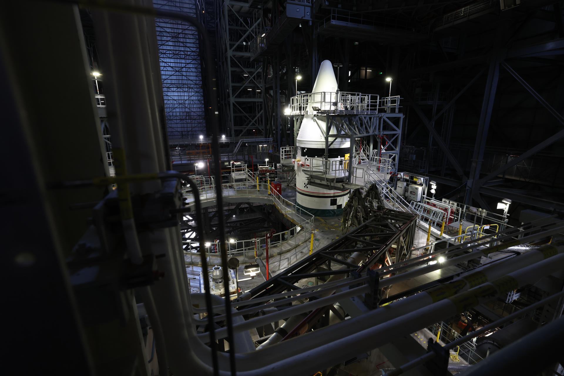 Engineers with NASA’s Exploration Ground Systems integrate the aerodynamic nose cone onto the left forward motor segment on the twin SLS (Space Launch System) solid rocket boosters for Artemis III inside the Vehicle Assembly Building’s High Bay 3 at NASA’s Kennedy Space Center in Florida on Tuesday, Sept. 29, 2026. Each forward assembly contains an aerodynamic top, a forward skirt housing avionics, and frustum housing motors that allow the boosters to separate from the SLS core stage after launch. The twin solid boosters will help support the remaining rocket components and the Orion spacecraft during final assembly of the Artemis III rocket and provide more than 75 percent of the total SLS thrust during liftoff from NASA Kennedy’s Launch Pad 39B.