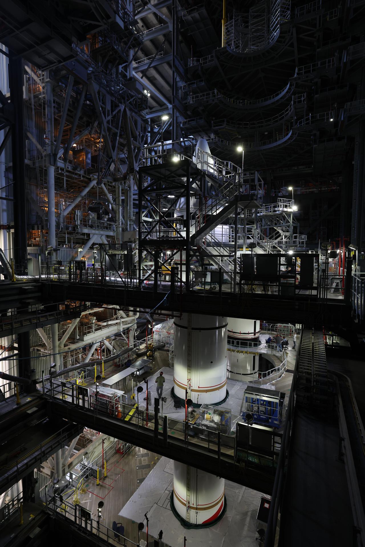 Engineers with NASA’s Exploration Ground Systems integrate the aerodynamic nose cone onto the left forward motor segment on the twin SLS (Space Launch System) solid rocket boosters for Artemis III inside the Vehicle Assembly Building’s High Bay 3 at NASA’s Kennedy Space Center in Florida on Tuesday, Sept. 29, 2026. Each forward assembly contains an aerodynamic top, a forward skirt housing avionics, and frustum housing motors that allow the boosters to separate from the SLS core stage after launch. The twin solid boosters will help support the remaining rocket components and the Orion spacecraft during final assembly of the Artemis III rocket and provide more than 75 percent of the total SLS thrust during liftoff from NASA Kennedy’s Launch Pad 39B.