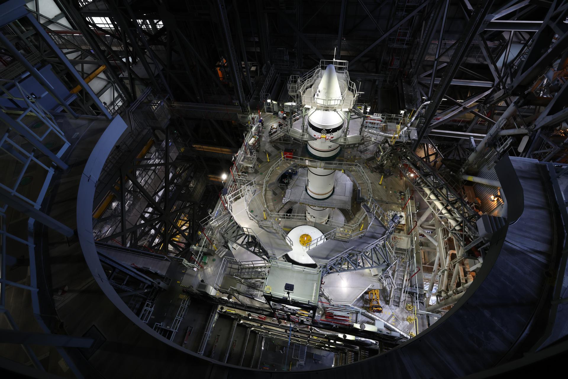 Engineers with NASA’s Exploration Ground Systems integrate the aerodynamic nose cone onto the left forward motor segment on the twin SLS (Space Launch System) solid rocket boosters for Artemis III inside the Vehicle Assembly Building’s High Bay 3 at NASA’s Kennedy Space Center in Florida on Tuesday, Sept. 29, 2026. Each forward assembly contains an aerodynamic top, a forward skirt housing avionics, and frustum housing motors that allow the boosters to separate from the SLS core stage after launch. The twin solid boosters will help support the remaining rocket components and the Orion spacecraft during final assembly of the Artemis III rocket and provide more than 75 percent of the total SLS thrust during liftoff from NASA Kennedy’s Launch Pad 39B.