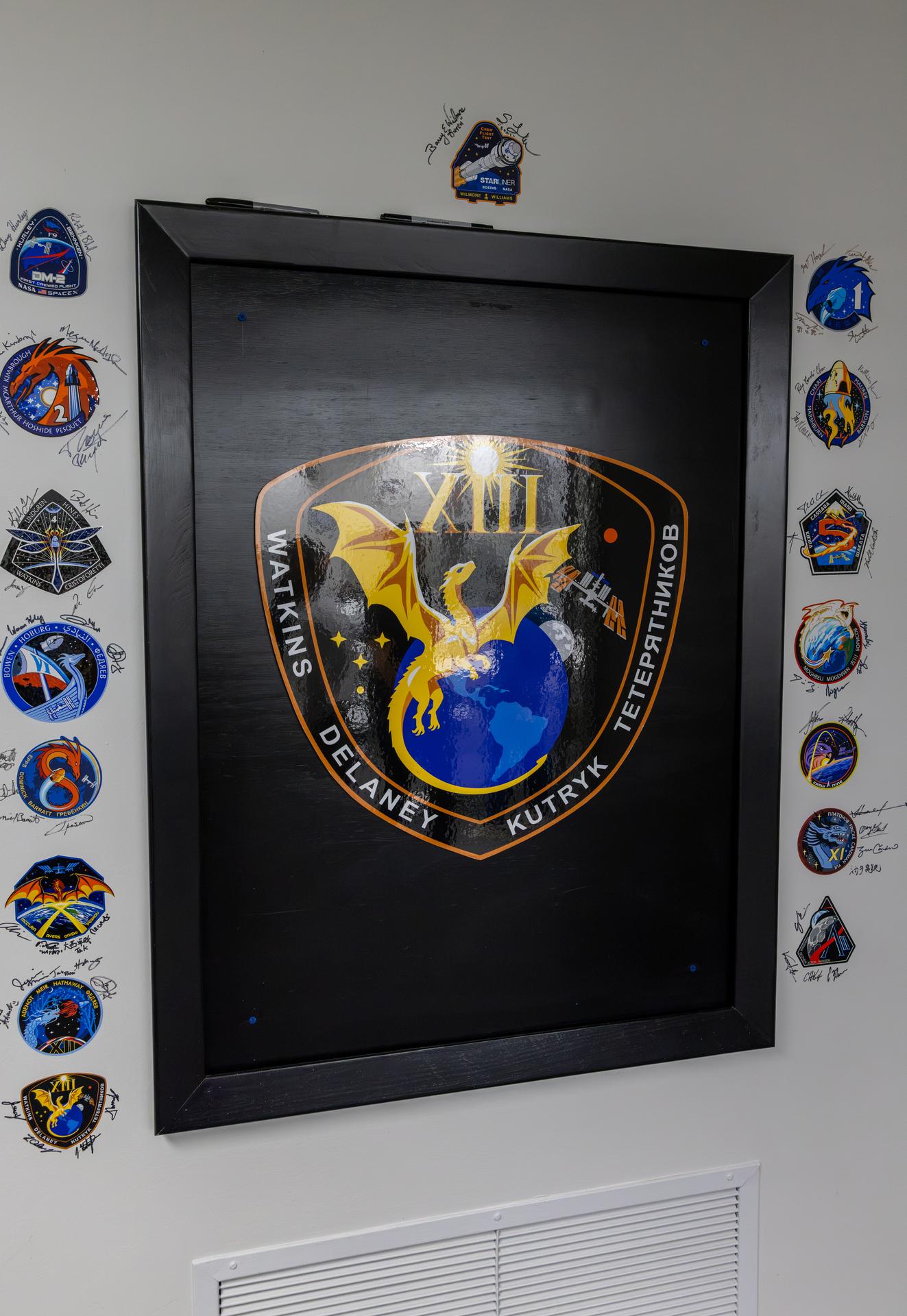 NASA’s SpaceX Crew-13 crew members NASA astronauts Jessica Watkins and Luke Delaney, along with CSA (Canadian Space Agency) astronaut Joshua Kutryk, and Roscosmos cosmonaut Sergey Teteryatnikov sign their names next to their mission insignia inside the Astronaut Crew Quarters in the Neil A. Armstrong Operations and Checkout Building at NASA’s Kennedy Space Center in Florida on Tuesday, Sept. 29, 2026. NASA’s SpaceX Crew-13 crew members will launch aboard a SpaceX Dragon spacecraft and Falcon 9 to the International Space Station no earlier than 11:10 a.m. EDT on Thursday, Oct. 1, from Cape Canaveral Space Force Station’s Space Launch Complex 40.