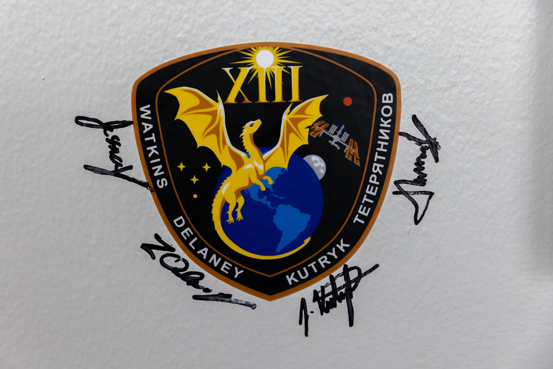 NASA’s SpaceX Crew-13 crew members NASA astronauts Jessica Watkins and Luke Delaney, along with CSA (Canadian Space Agency) astronaut Joshua Kutryk, and Roscosmos cosmonaut Sergey Teteryatnikov sign their names next to their mission insignia inside the Astronaut Crew Quarters in the Neil A. Armstrong Operations and Checkout Building at NASA’s Kennedy Space Center in Florida on Tuesday, Sept. 29, 2026. NASA’s SpaceX Crew-13 crew members will launch aboard a SpaceX Dragon spacecraft and Falcon 9 to the International Space Station no earlier than 11:10 a.m. EDT on Thursday, Oct. 1, from Cape Canaveral Space Force Station’s Space Launch Complex 40.