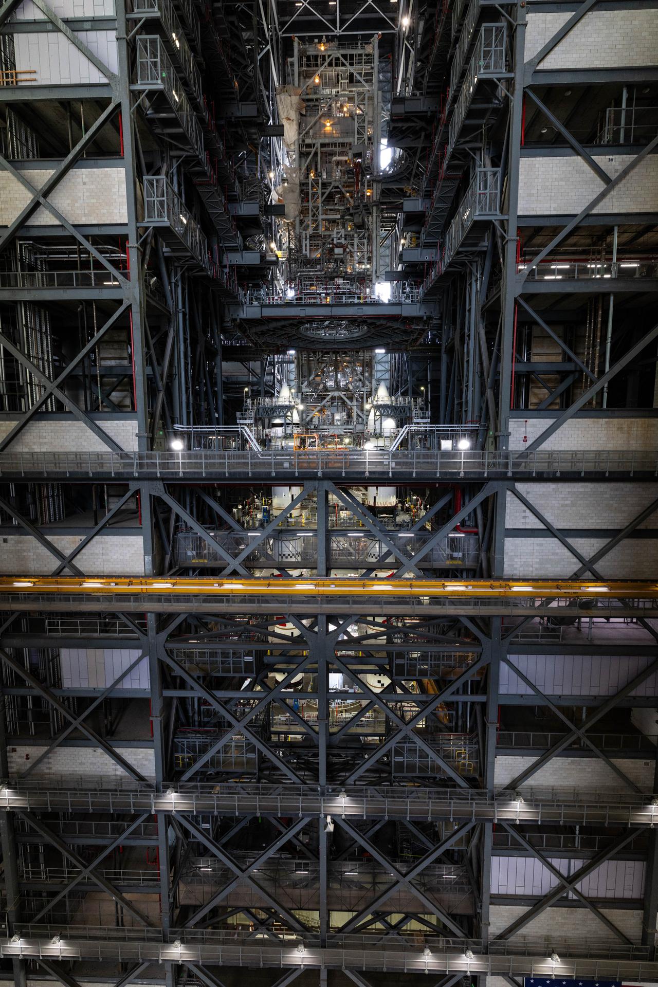 Engineers with NASA’s Exploration Ground Systems completed integrating the aerodynamic nose cones onto the left and right forward assemblies on the twin SLS (Space Launch System) solid rocket boosters, finishing their stacking operations for Artemis III inside the Vehicle Assembly Building’s High Bay 3 at NASA’s Kennedy Space Center in Florida on Wednesday, Sept. 30, 2026. Each forward assembly contains an aerodynamic top, a forward skirt housing avionics, and frustum housing motors that allow the boosters to separate from the SLS core stage after launch. The twin solid boosters will help support the remaining rocket components and the Orion spacecraft during final assembly of the Artemis III rocket and provide more than 75 percent of the total SLS thrust during liftoff from NASA Kennedy’s Launch Pad 39B.