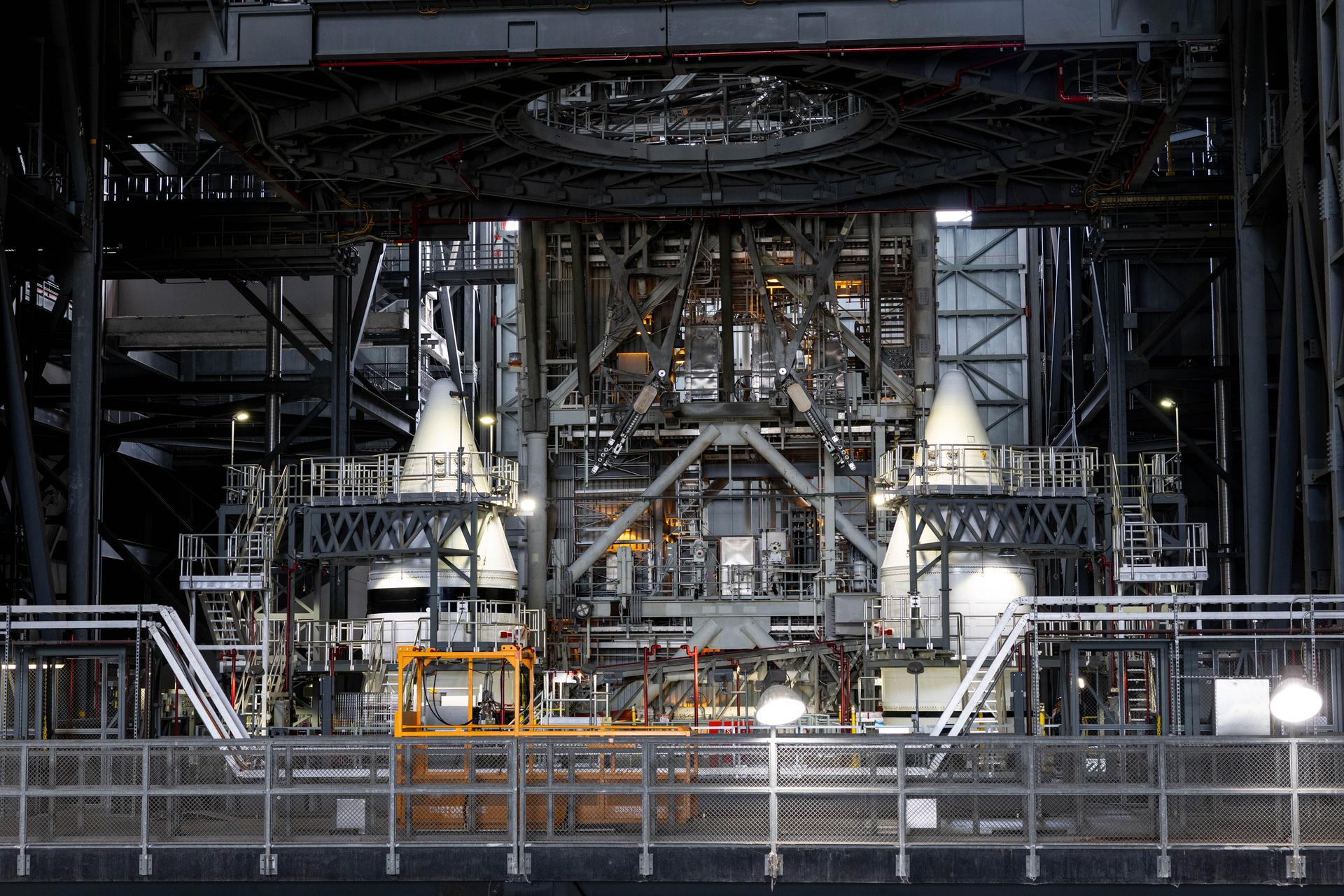 Engineers with NASA’s Exploration Ground Systems completed integrating the aerodynamic nose cones onto the left and right forward assemblies on the twin SLS (Space Launch System) solid rocket boosters, finishing their stacking operations for Artemis III inside the Vehicle Assembly Building’s High Bay 3 at NASA’s Kennedy Space Center in Florida on Wednesday, Sept. 30, 2026. Each forward assembly contains an aerodynamic top, a forward skirt housing avionics, and frustum housing motors that allow the boosters to separate from the SLS core stage after launch. The twin solid boosters will help support the remaining rocket components and the Orion spacecraft during final assembly of the Artemis III rocket and provide more than 75 percent of the total SLS thrust during liftoff from NASA Kennedy’s Launch Pad 39B.